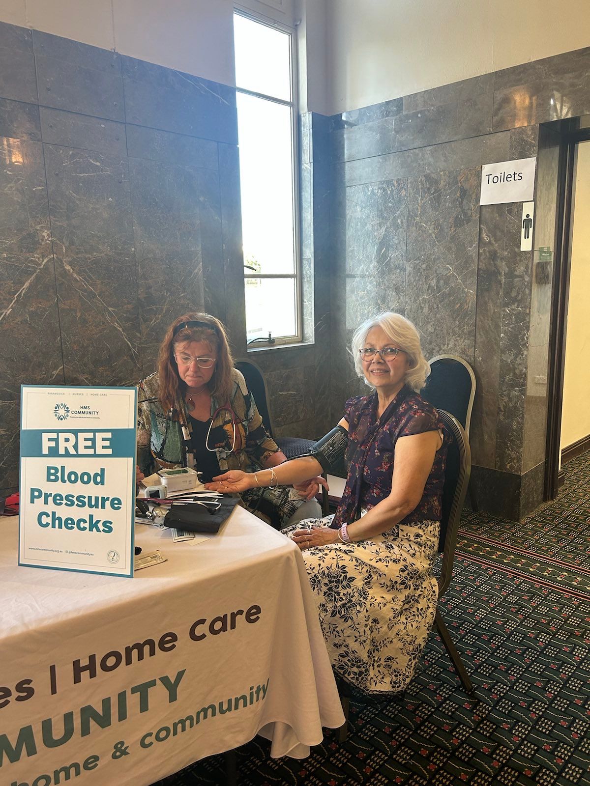 two people. one taking a blood pressure