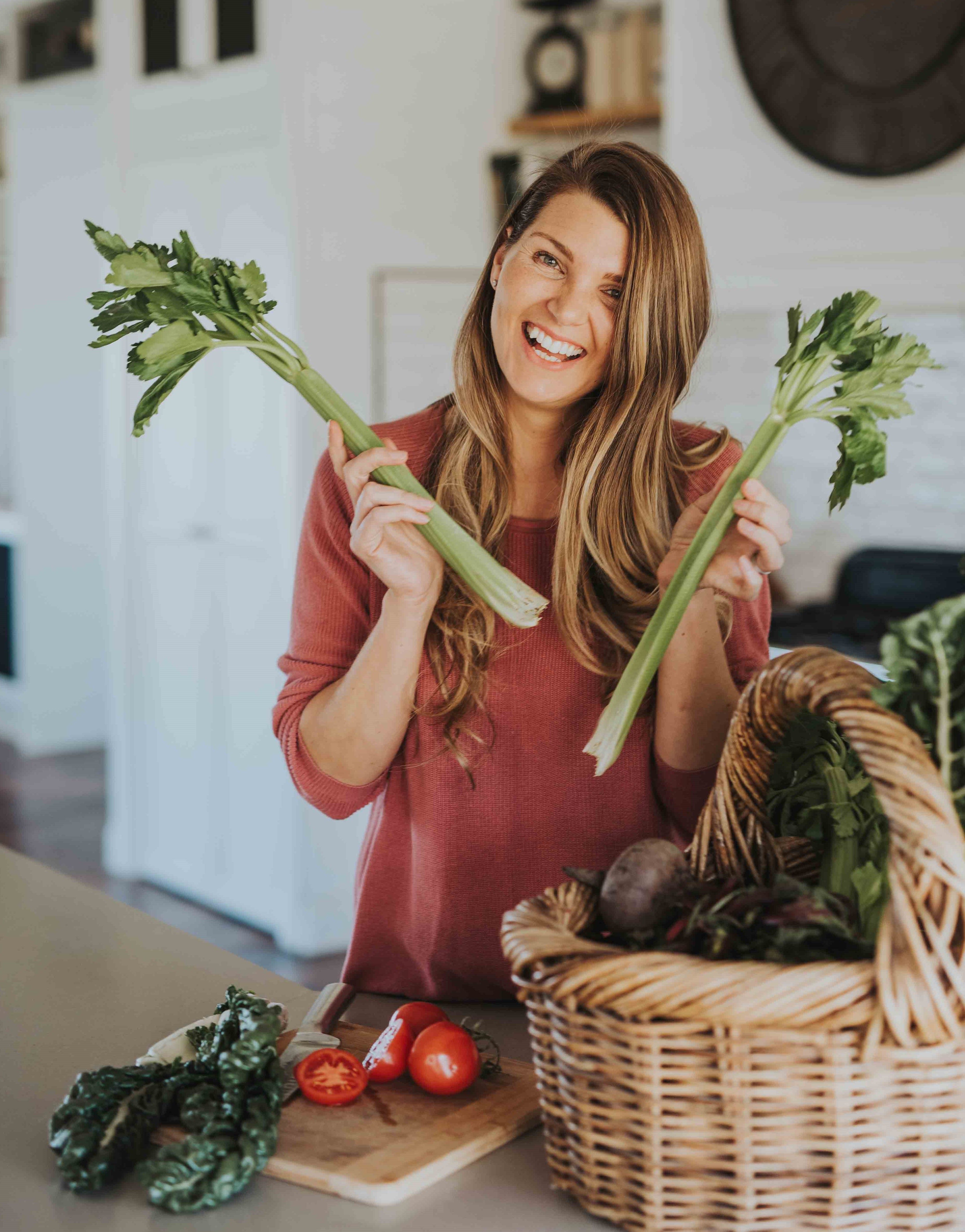 Danyel smiling and holding celery