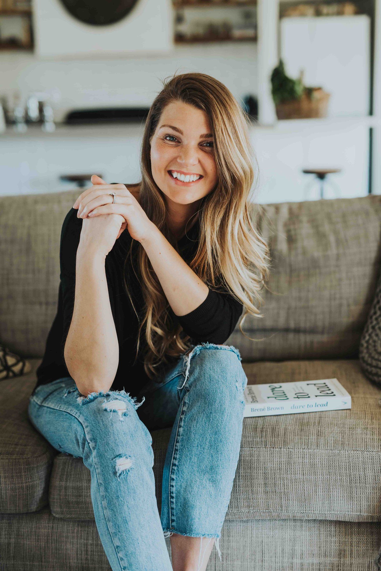 Danyel smiling on a couch