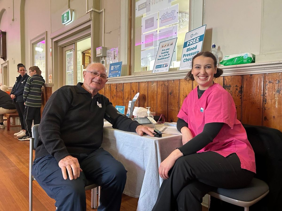 Man and a female paramedic at a health check 