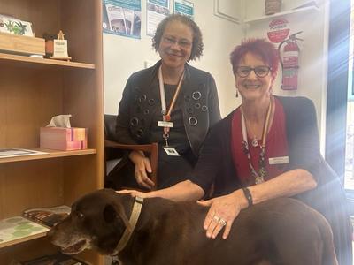 two people with a dog