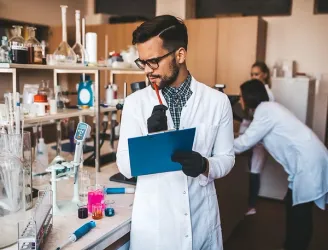 Diverse group of scientists collaborating in a modern laboratory setting.
