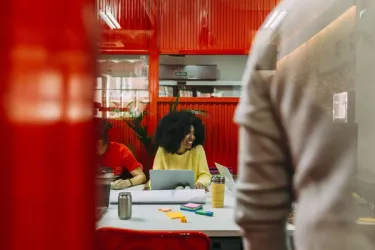 Female founders collaborating on AI technology in a modern office space.