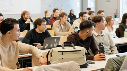 A diverse group of migrant entrepreneurs collaborating in a modern workspace.
