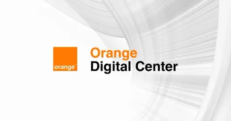 Diverse group of participants collaborating on AI projects at the Orange Summer Challenge.
