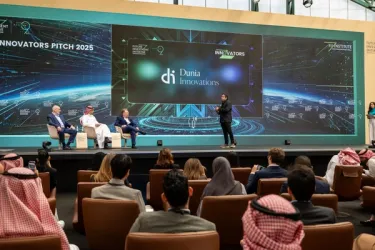 Innovators pitching their AI solutions on stage at the FII Institute event.