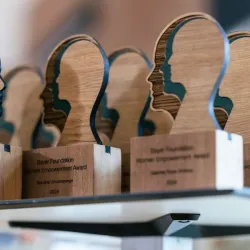 A diverse group of women entrepreneurs collaborating during an accelerator program.