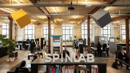 SpinLab accelerator team collaborating in a modern office space.