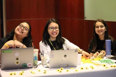 Students collaborating on laptops during the Sunflower Hackathon.