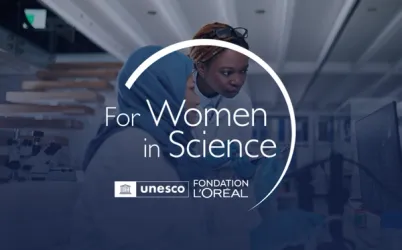 A group of diverse female scientists collaborating in a modern laboratory.