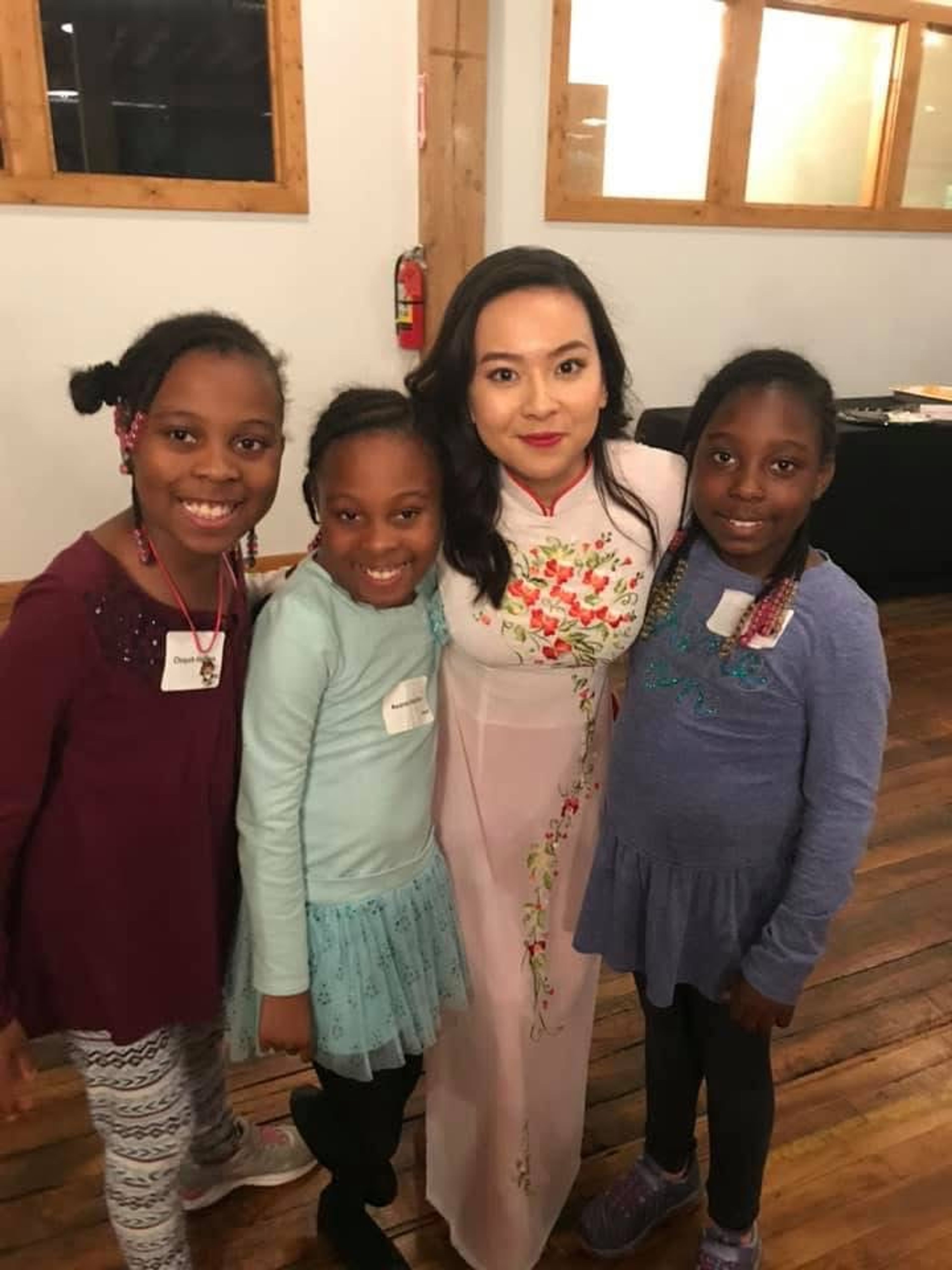 Van proudly wearing her ao dai while working in the US
