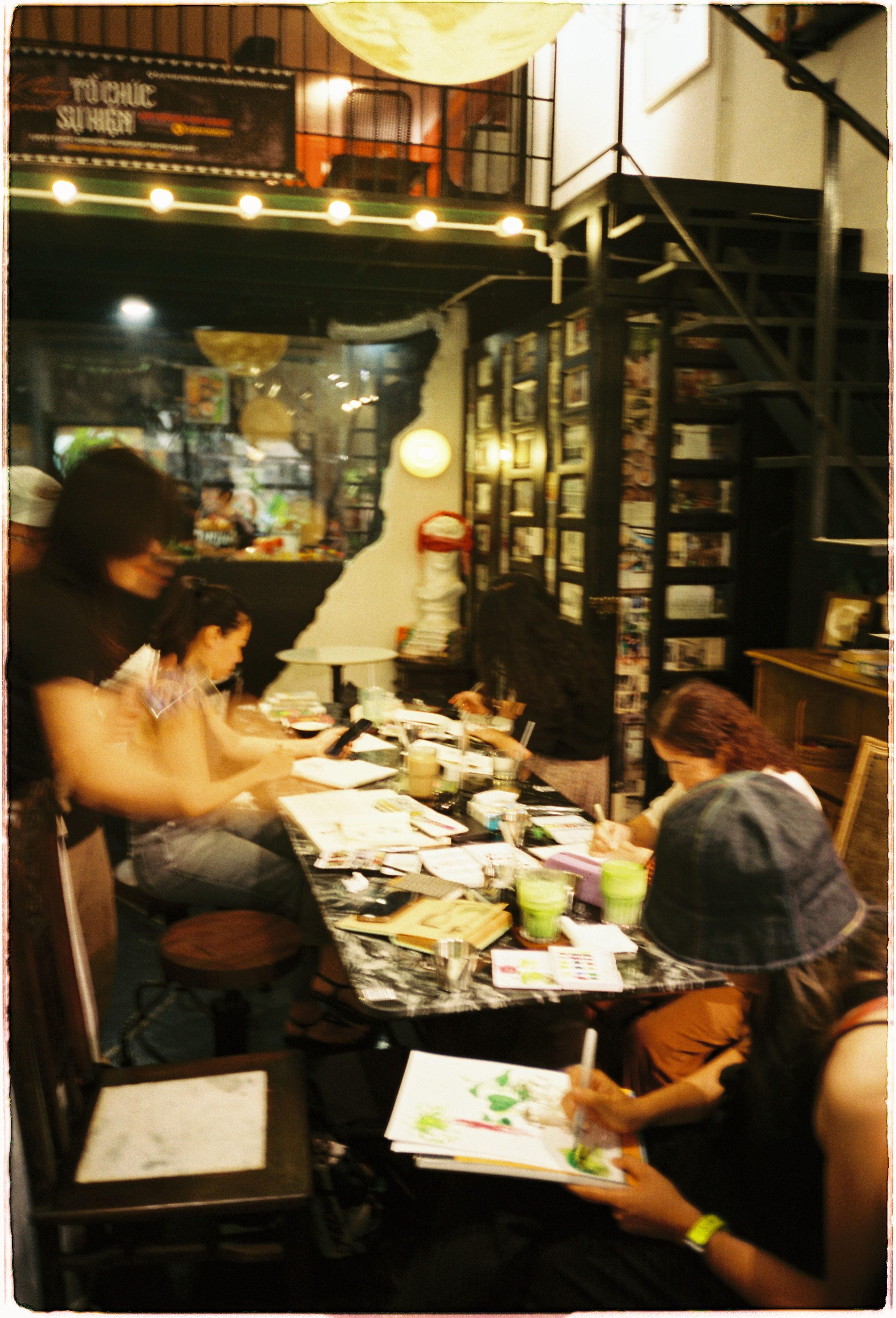 people drawing in a cafe 