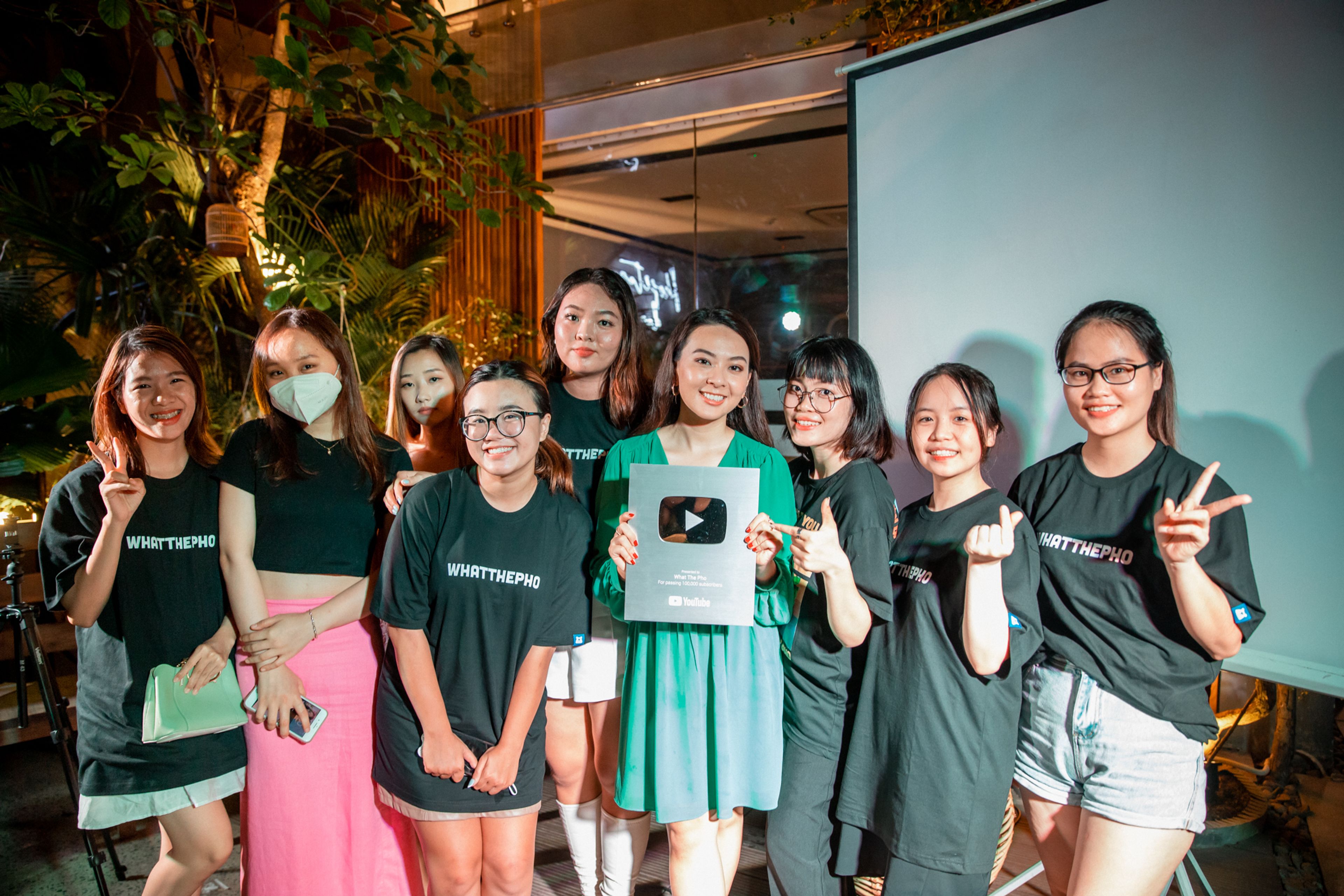 Van's team celebrating a silver YouTube plaque 