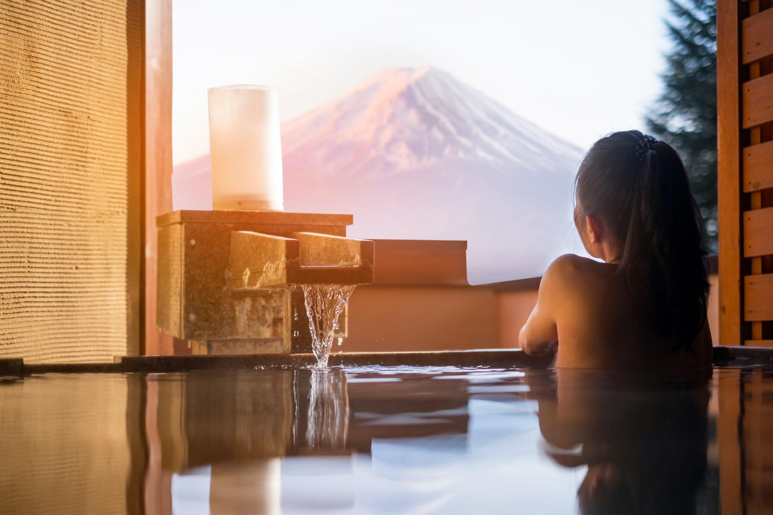 A woman relaxes in a Japanese onsen./Shutterstock