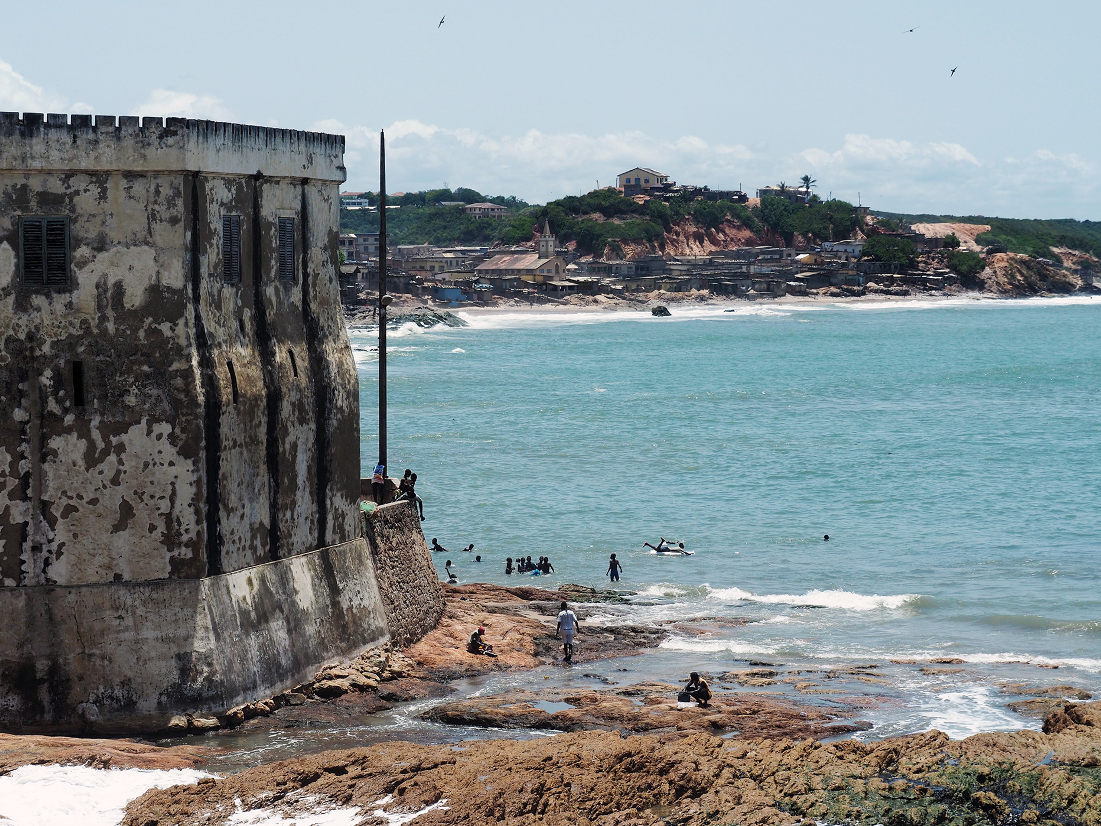 Children now play in the surf next to Cape Coast Castle/ Alexandra Yingst