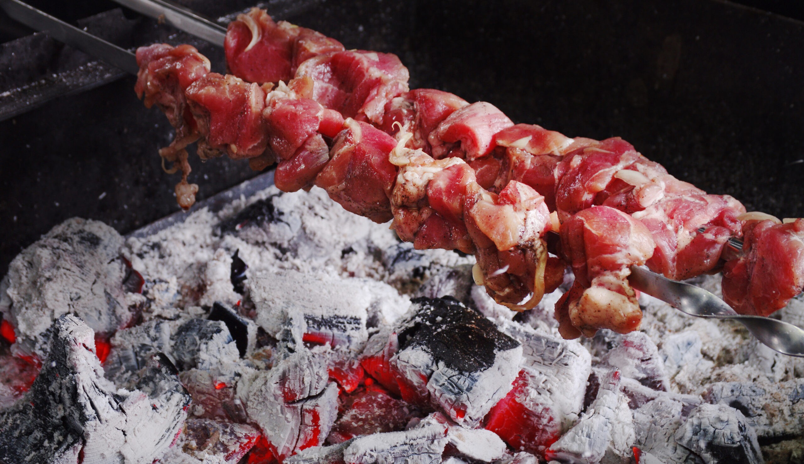 Mishkak, a popular street food, makes a savory grab-and-go for those who want to dine on the beaches of Oman./Shutterstock