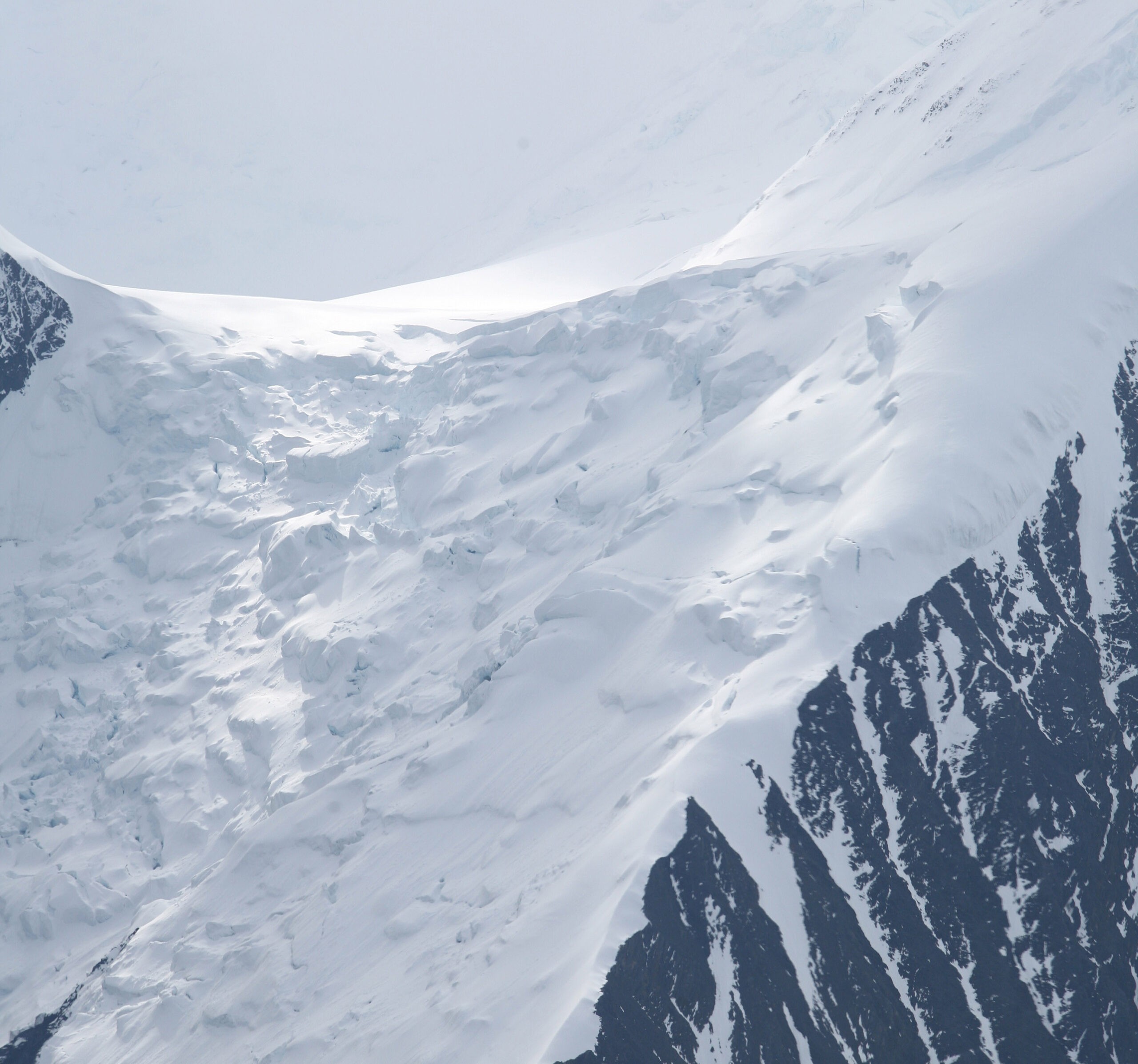 Using a polarizer, an aerial close-up view of sunlight on a glacier on the summit of Mount McKinley, Alaska, reveals beautiful striations on the right. Such a lens helps cut down on glare, especially with snow shots./Getty Images
