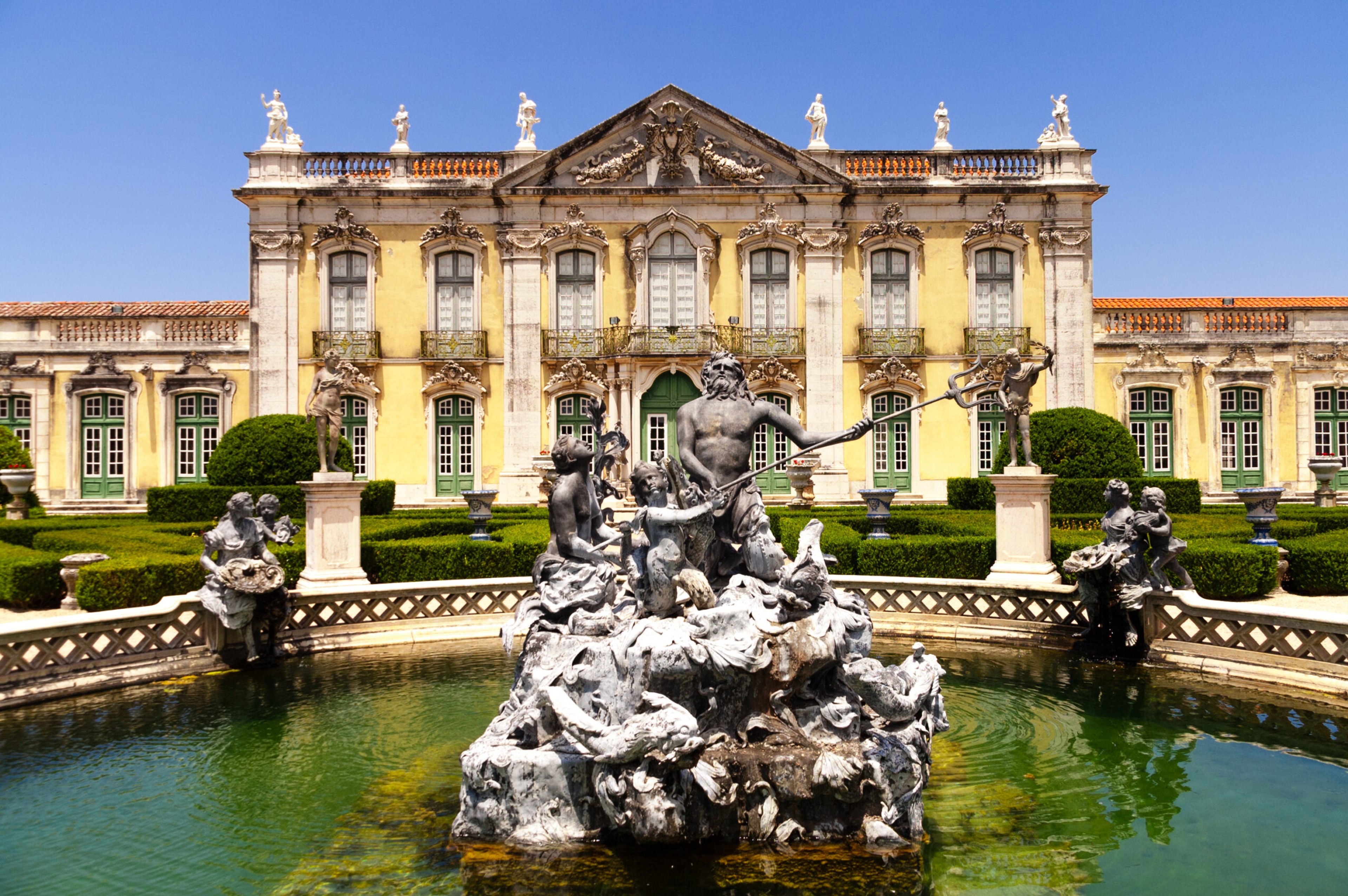 Facade of Queluz National Palace, and Neptune fountain between Lisbon and Sintra./Shutterstock
