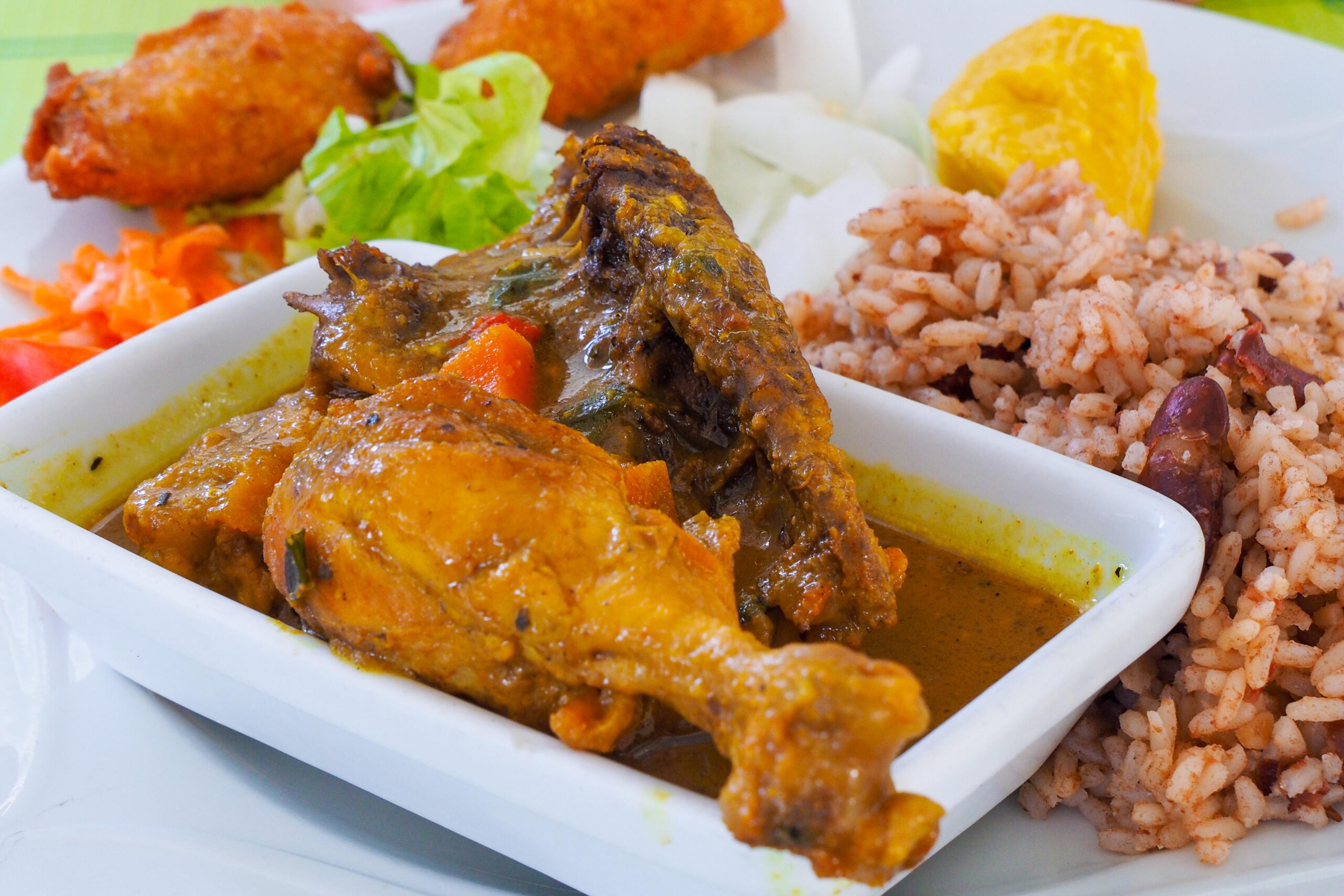 Chicken Colombo, typical dish of Guadeloupe, made with chicken legs and spices and often served with accras, puffy fritters./Shutterstock