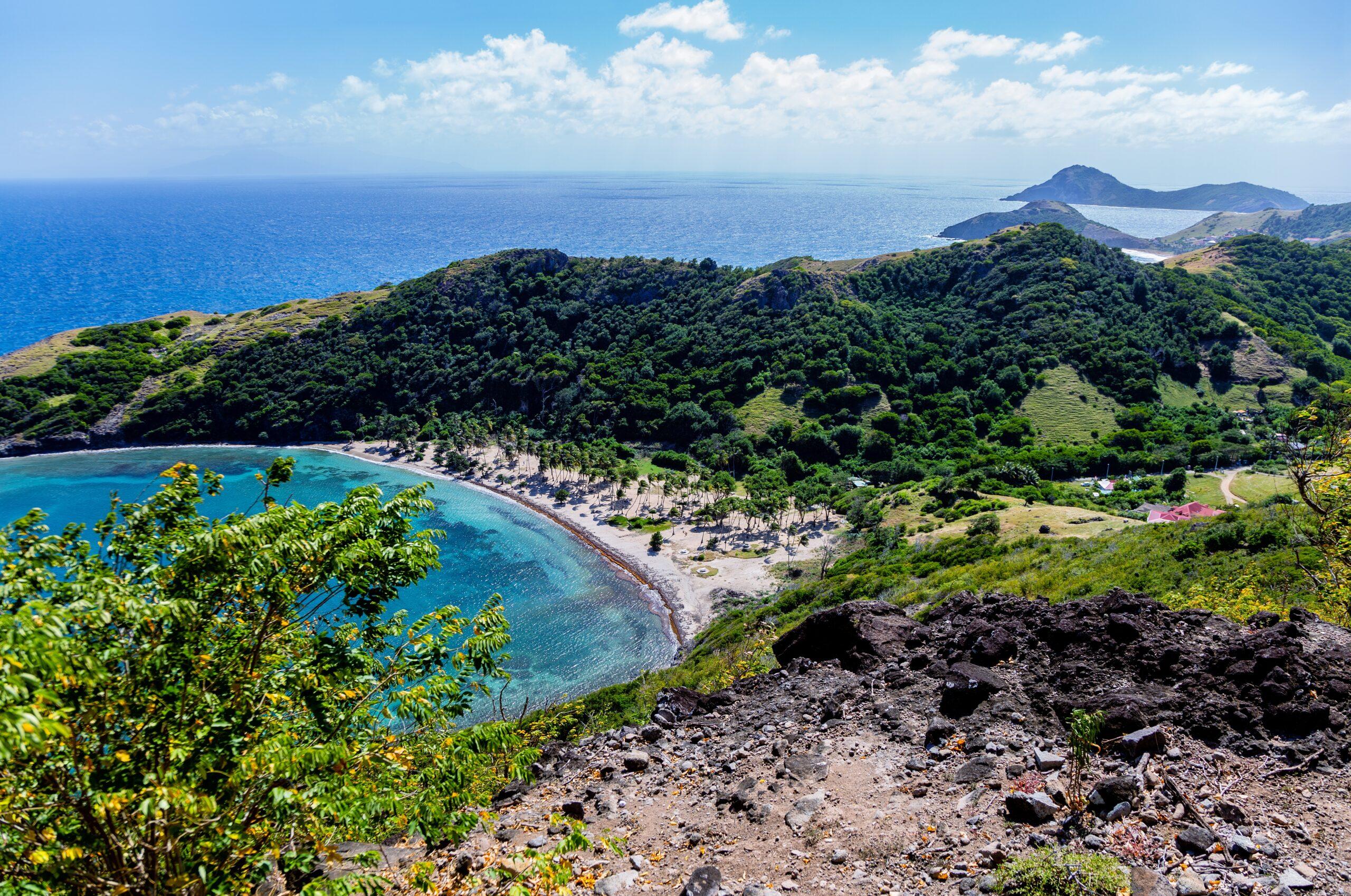 From the Morne Morel hiking trail, you can see the quiet crescent of the Beach Anse Pompierre on the islet of Terre-de-Haut, Guadeloupe./Shutterstock