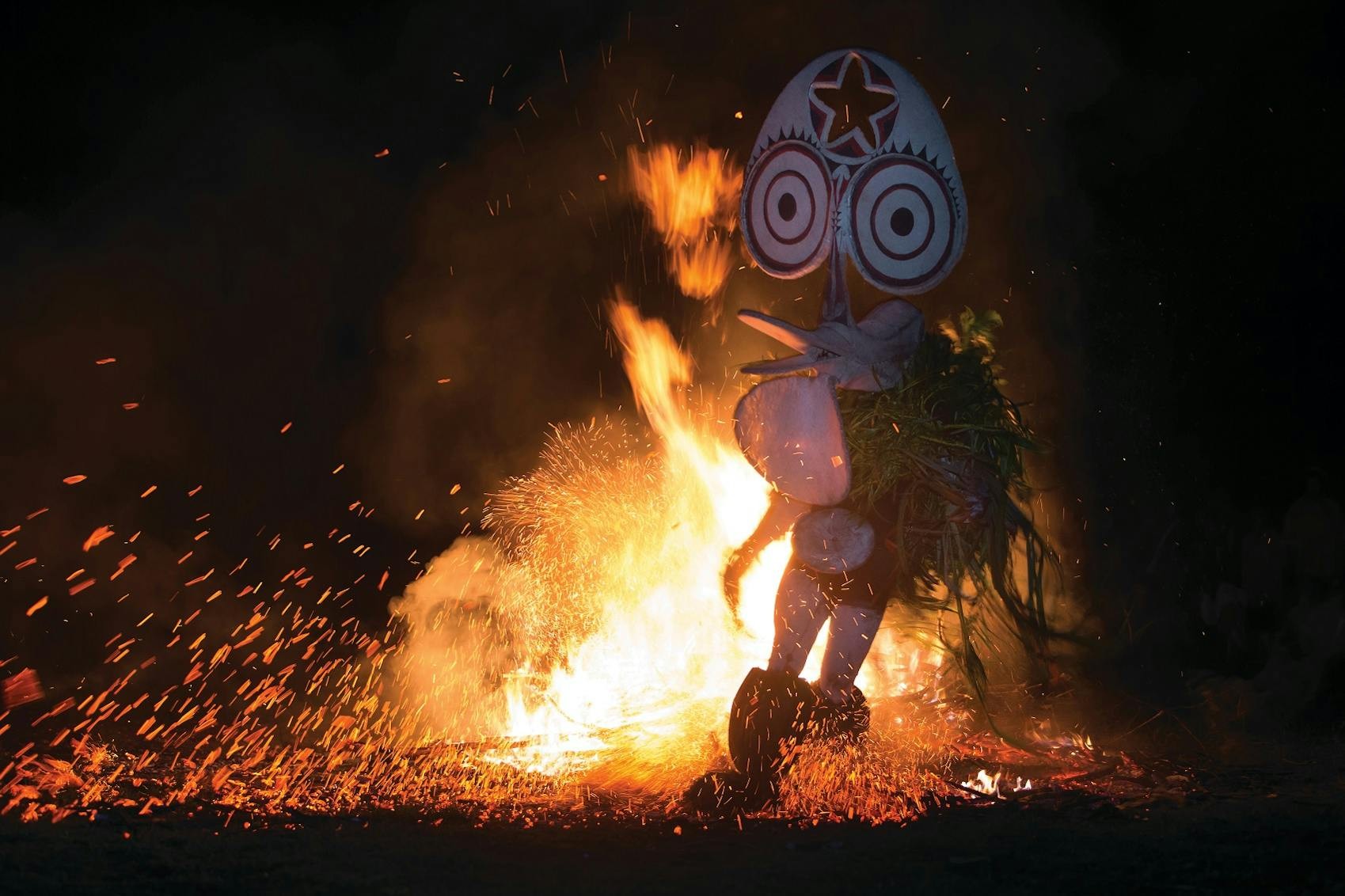 A participant displays impressive head wear during a traditional fire dancing ceremony/Richard Sidey