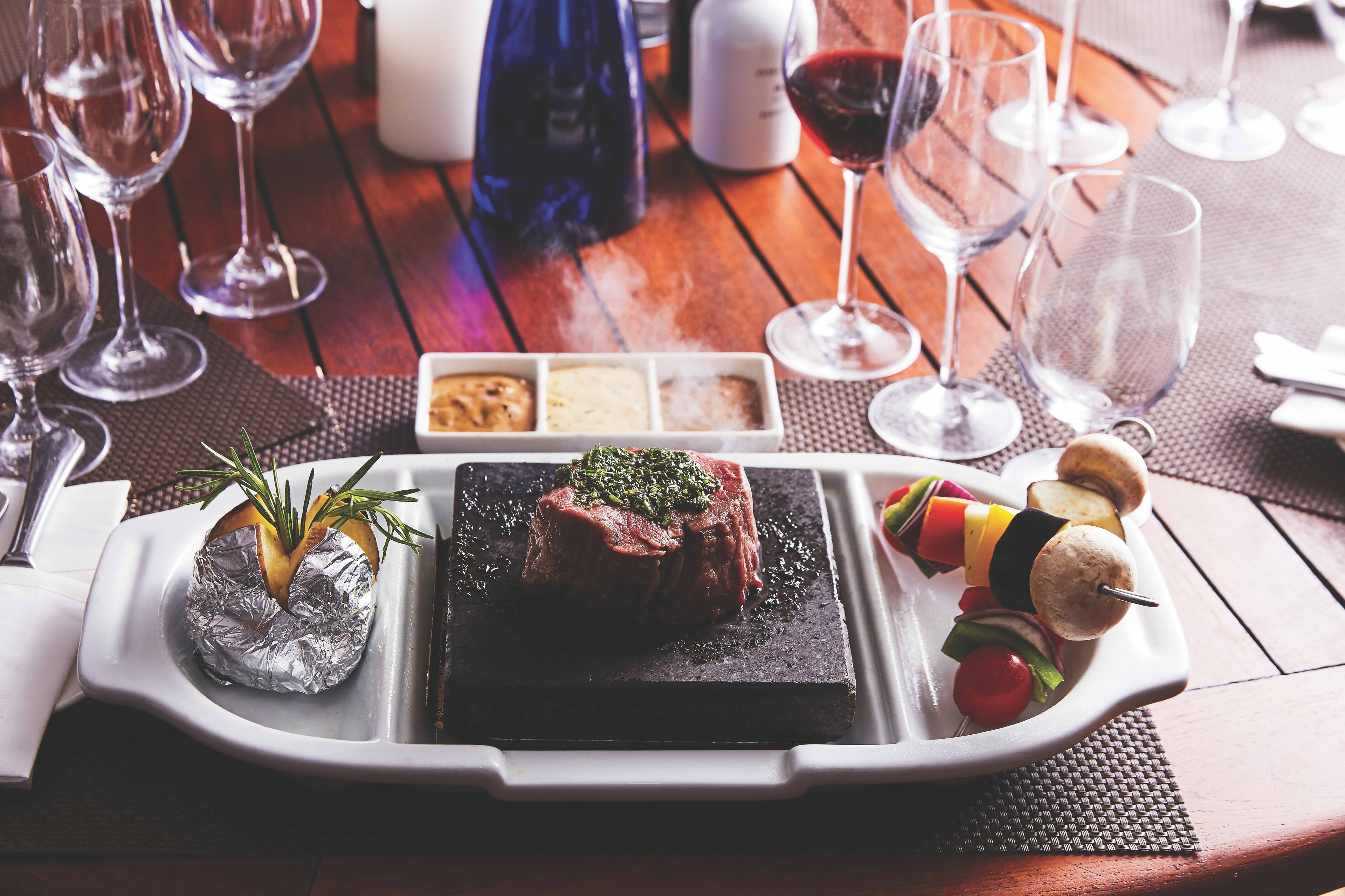 An alfresco dinner on an Arctic cruise with a new friend at the Hot Rocks Grill was a wonderful moment./Silversea Photo