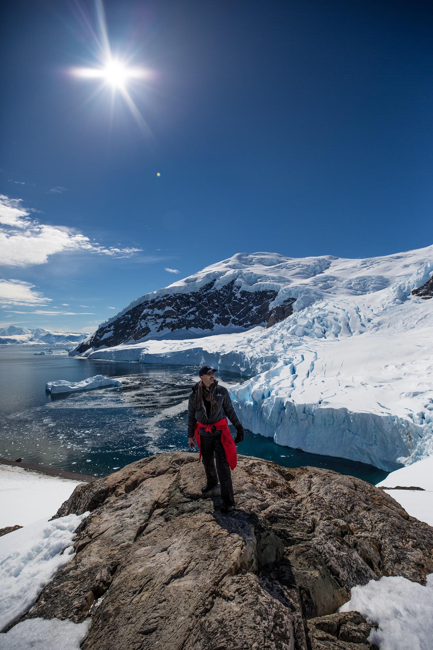 One of Silversea's guests stands atop a rock in Neko Harbour/Ross Vernon McDonald