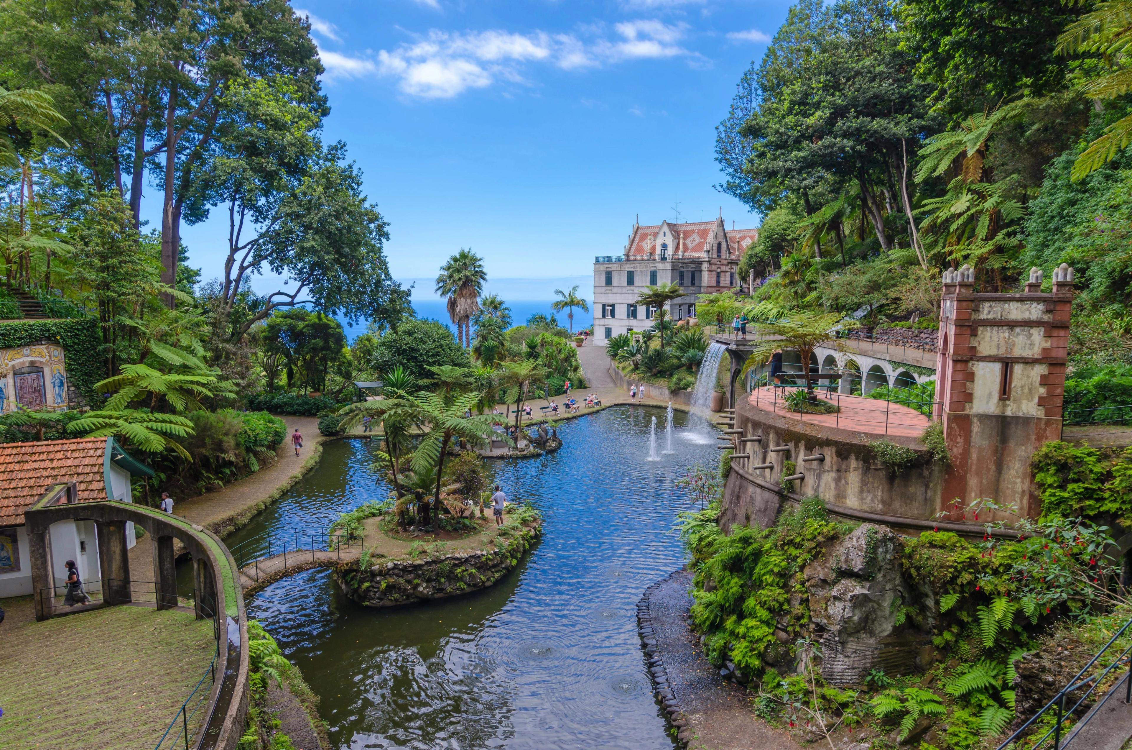 Lush tropical gardens surround a serene pond and fountains on beautiful Madeira island.