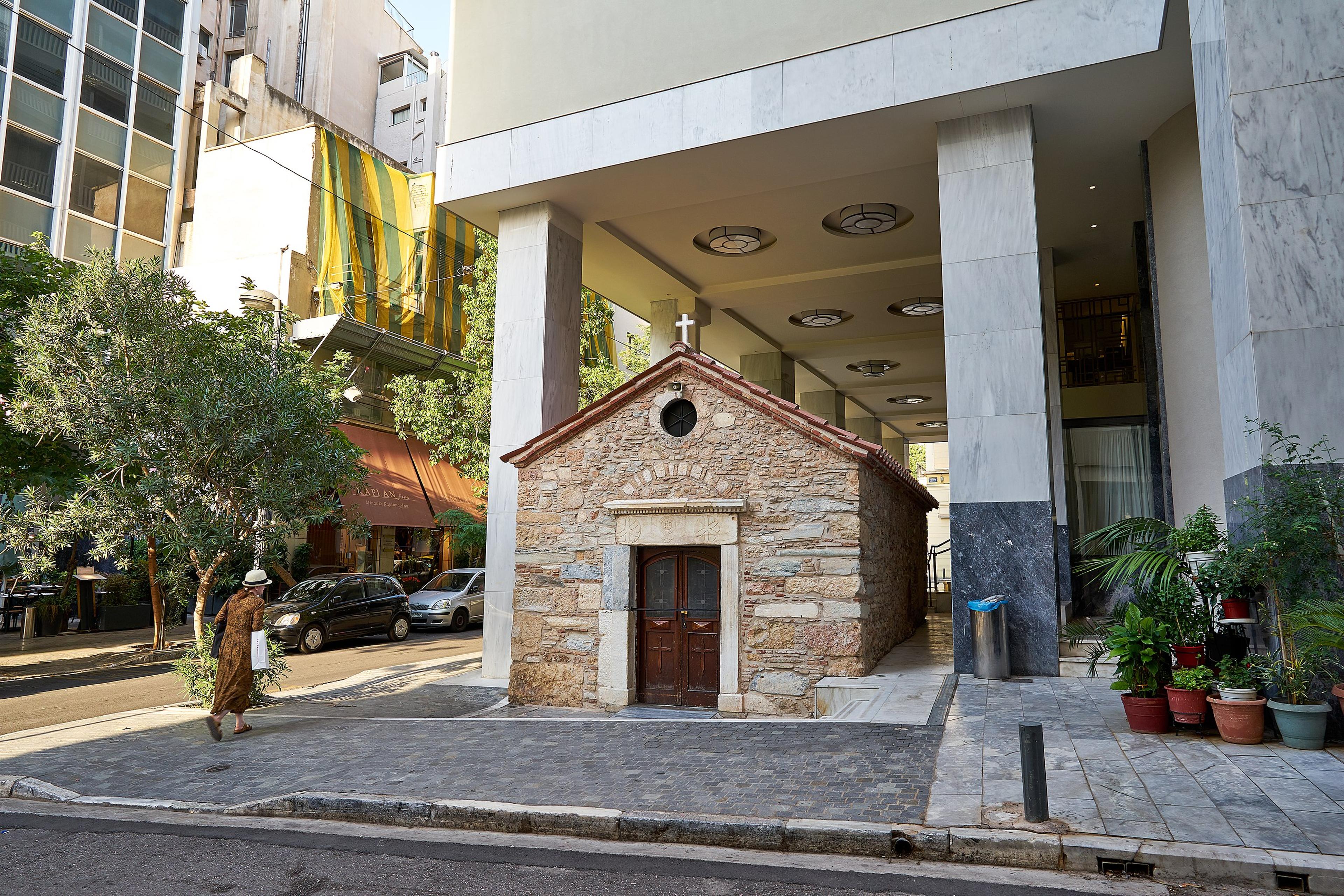 Where else but Athens can you find a church that dates back 500 years and is cheek-by-jowl with a modern hotel?/Wikimedia Commons Photo by George E. Koronaios