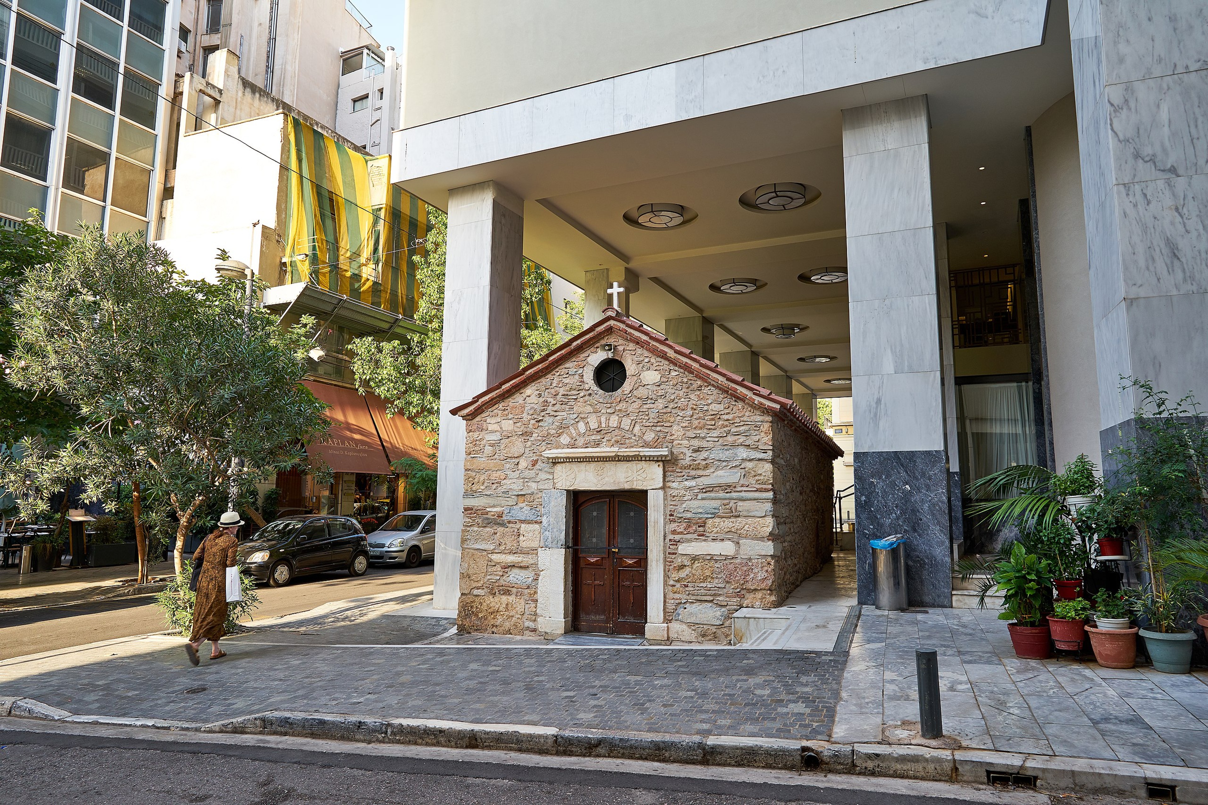 Where else but Athens can you find a church that dates back 500 years and is cheek-by-jowl with a modern hotel?/Wikimedia Commons Photo by George E. Koronaios