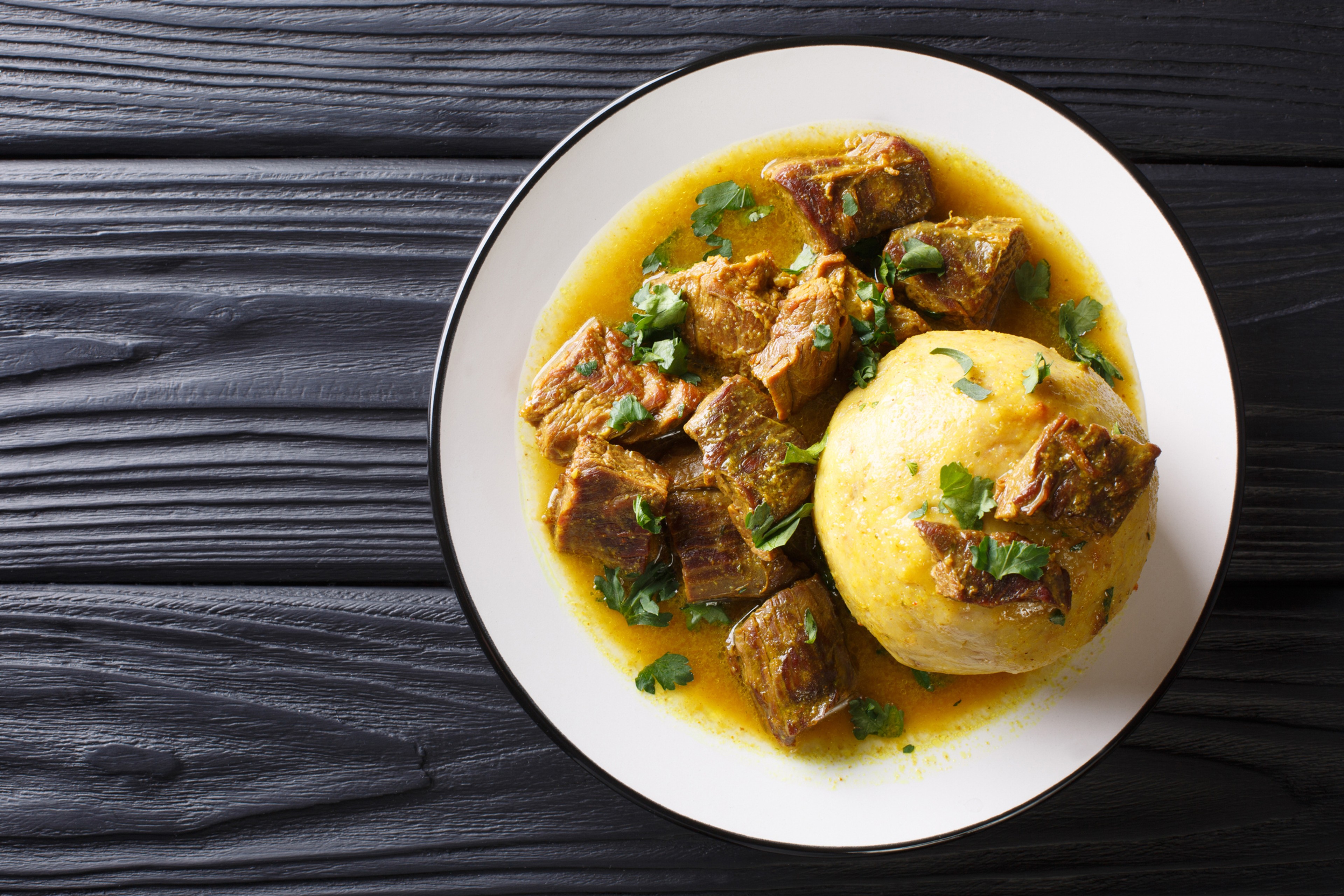 In Puerto Rico, Mofongo, which incorporates plantains, garlic and chicharron served with meat and broth, is influenced by African cultures./Getty