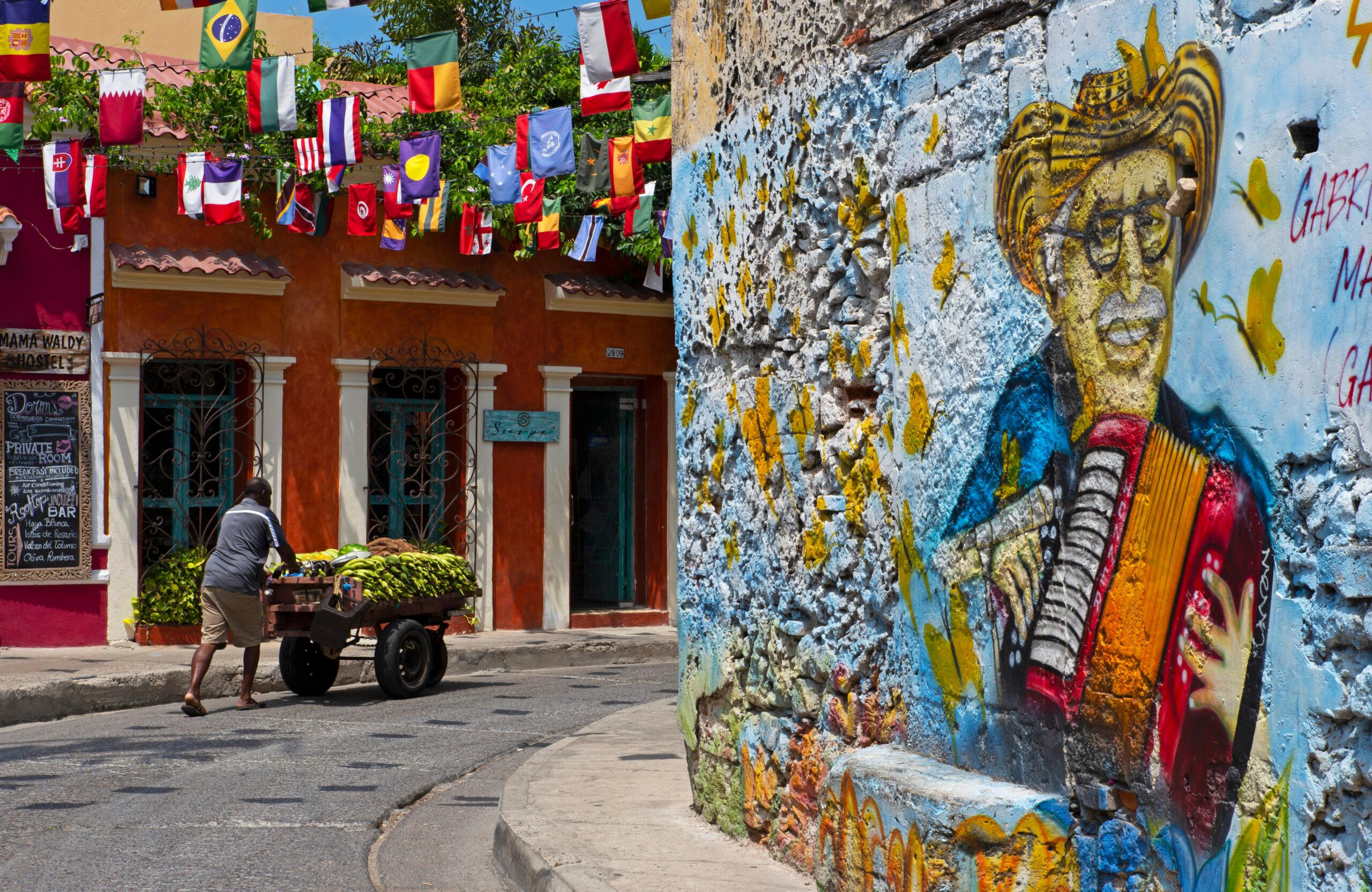 Vendor with his fruit cart in a colorful street in Getsemaní/Getty Images