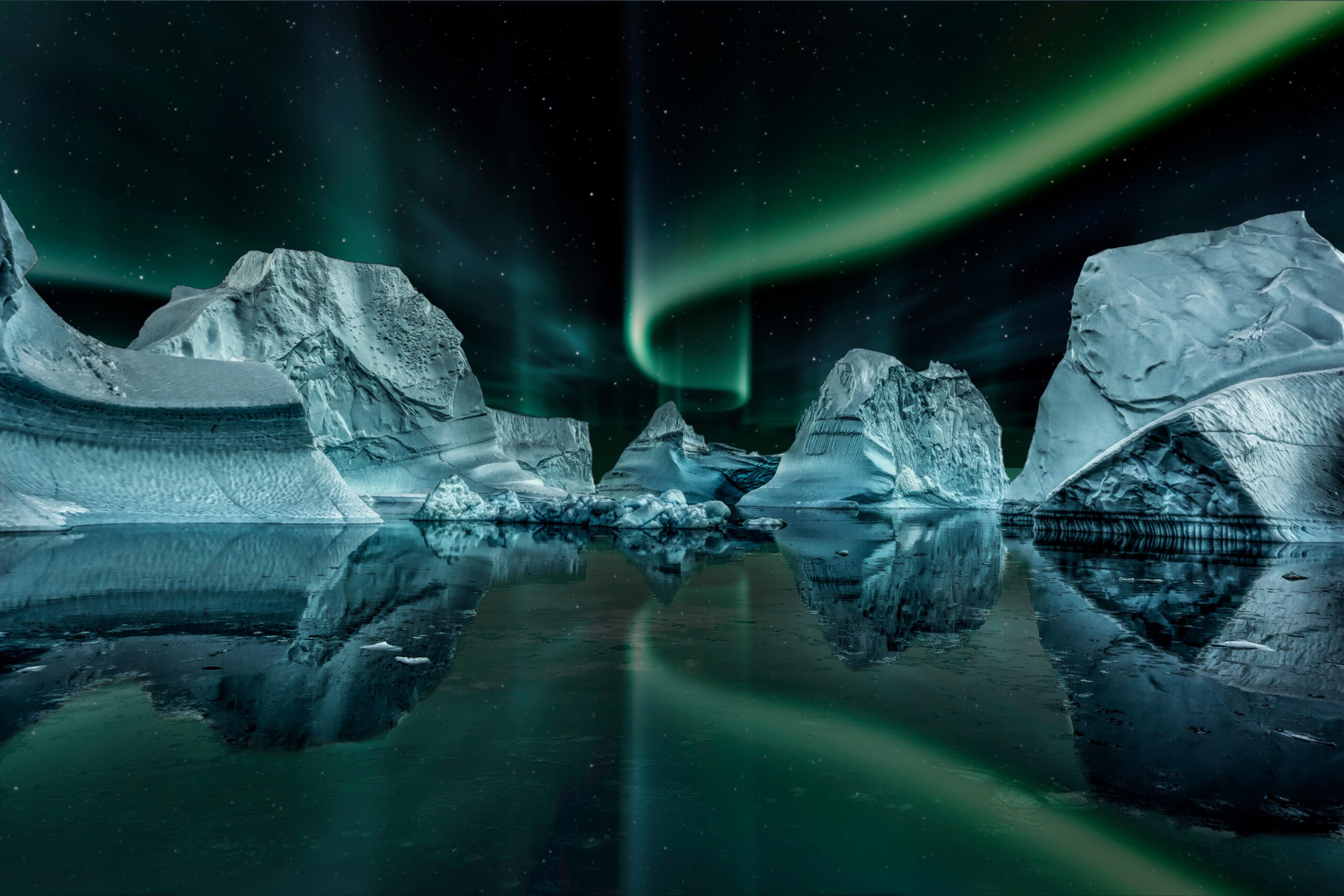 Northern Lights across reflect in a fiord in Greenland./Shutterstock