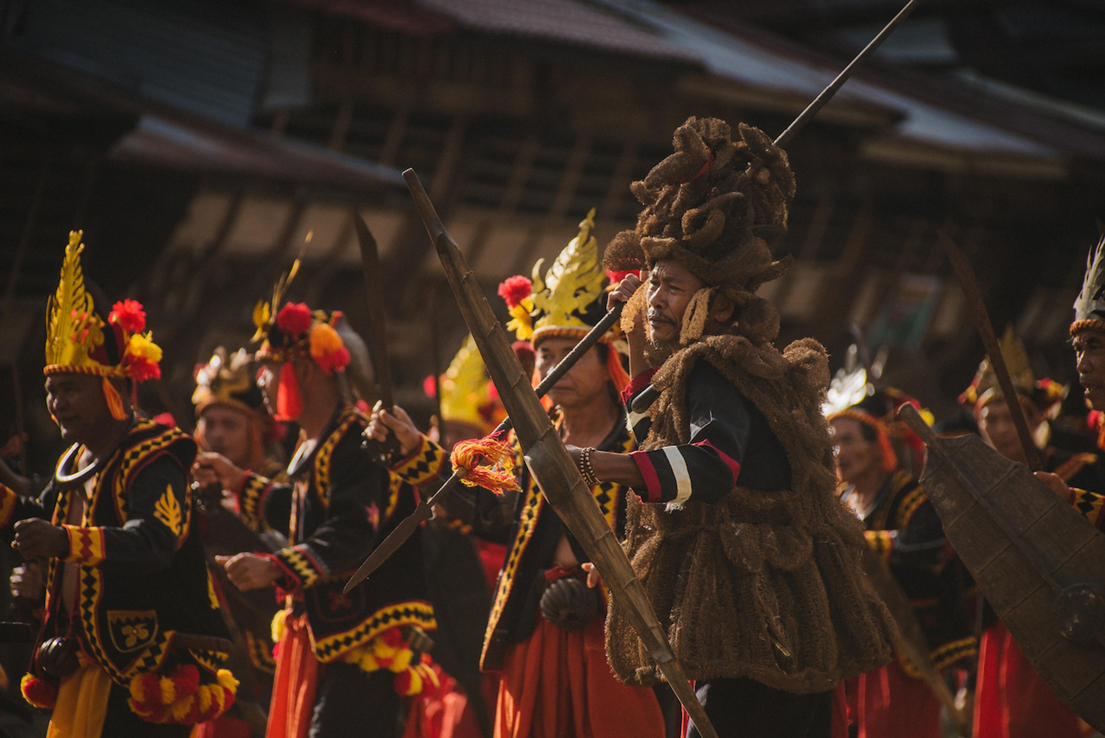 The locals' striking costumes add color to the tradition of stone jumping/Willem Van den Heeve
