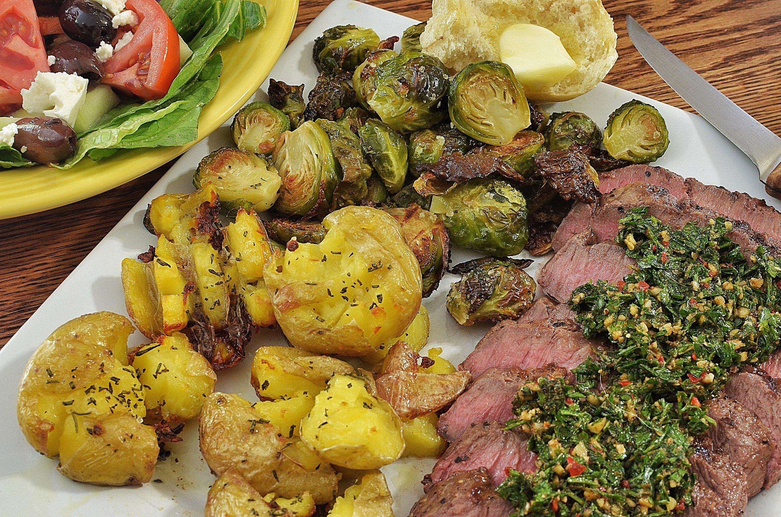 Chimichurri, the parsley-laced sauce, is what's for dinner, or at least, with this dinner of flat-iron steak./Wikimedia Commons photo by jeffreyw