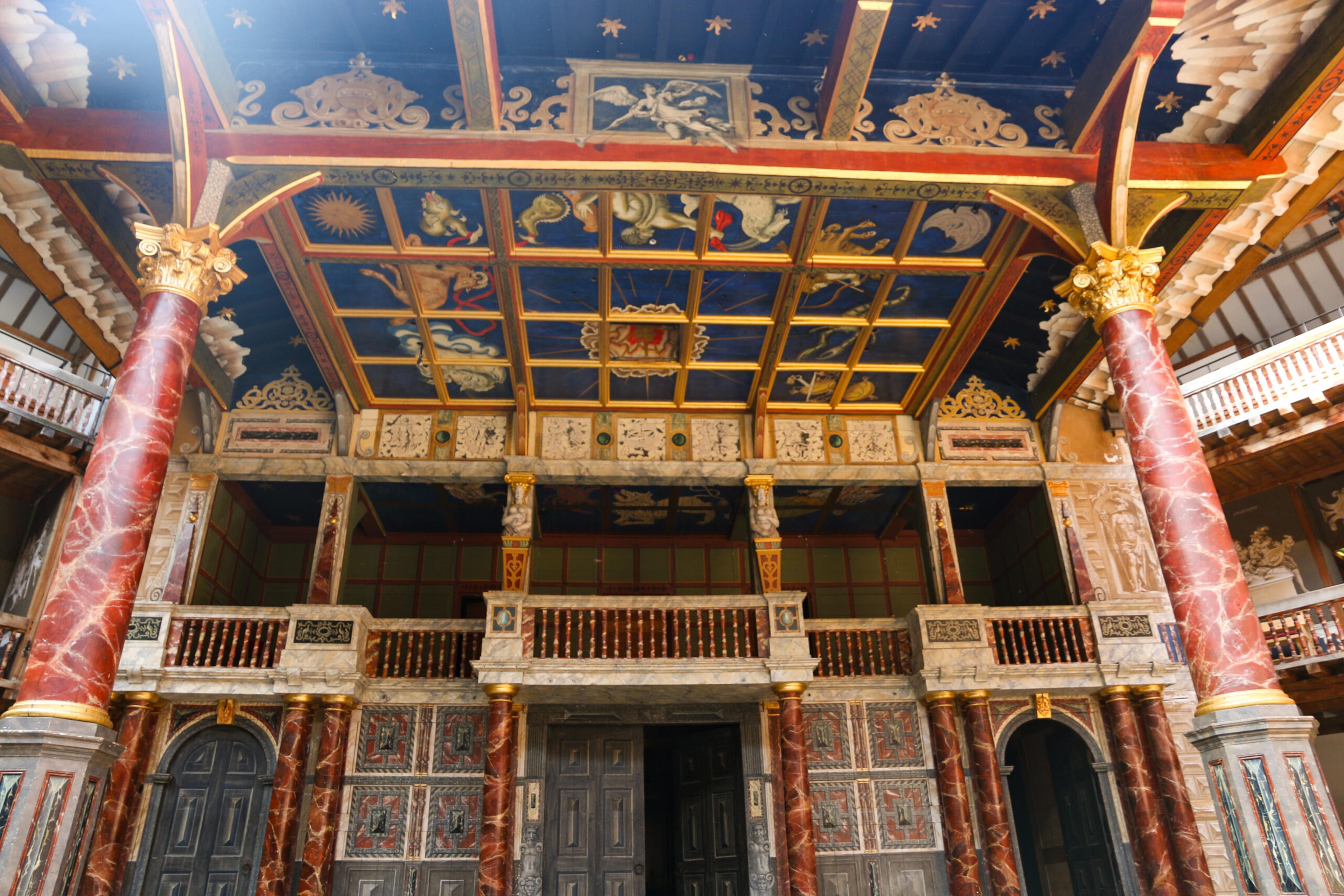 The Globe's stage roof decorated with pictures and symbols in the original theater in London/Getty Images