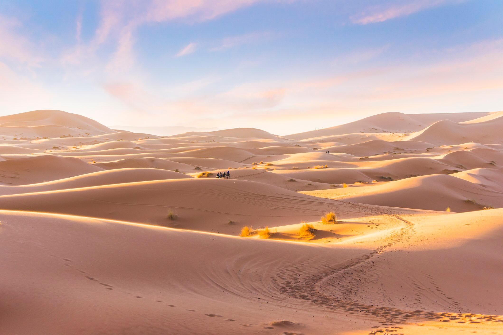 Riding camels through the Sahara in Morocco/Getty Images