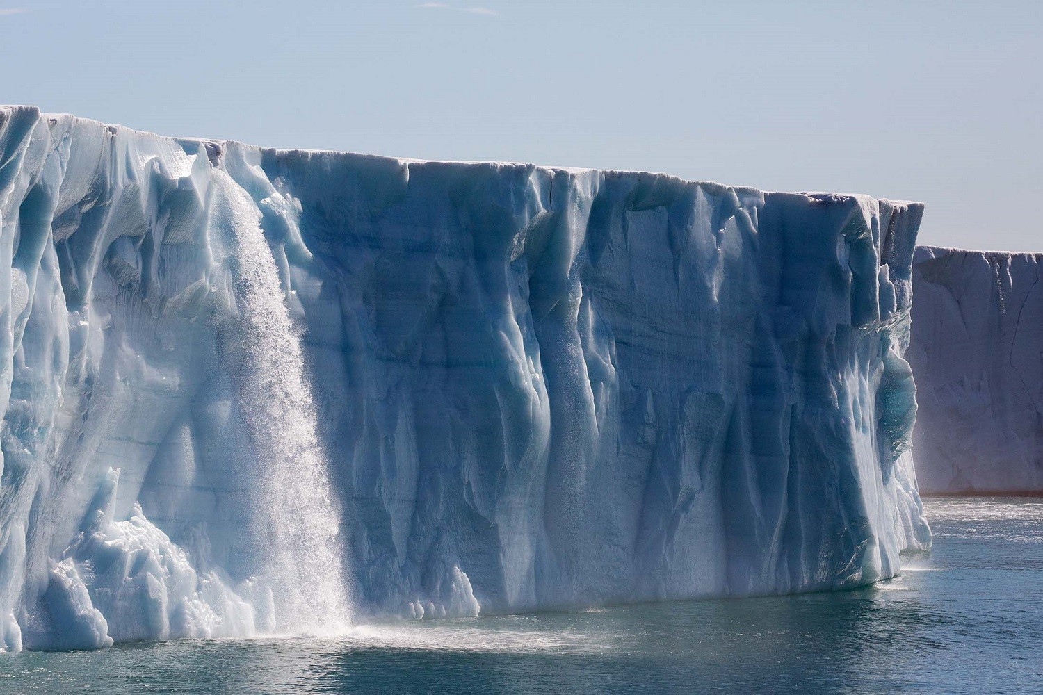 Glacial runoff gushes into the sea from atop the Brasvellbreen Glacier, Svalbard/Denis Elterman