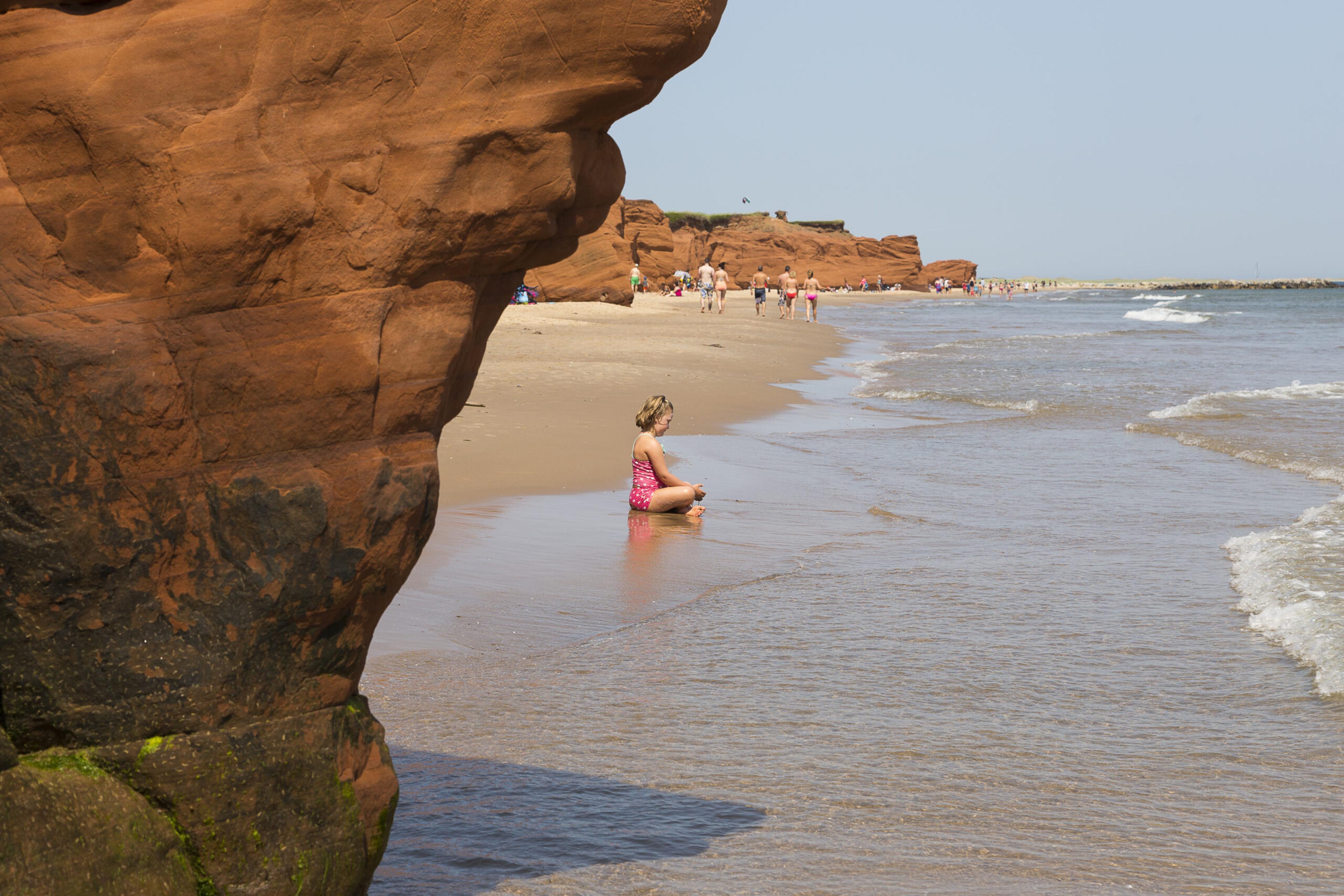 Dune-du-Sud, the red cliff in the foreground, at Havre aux Maisons, Magdalen Islands./Shutterstock