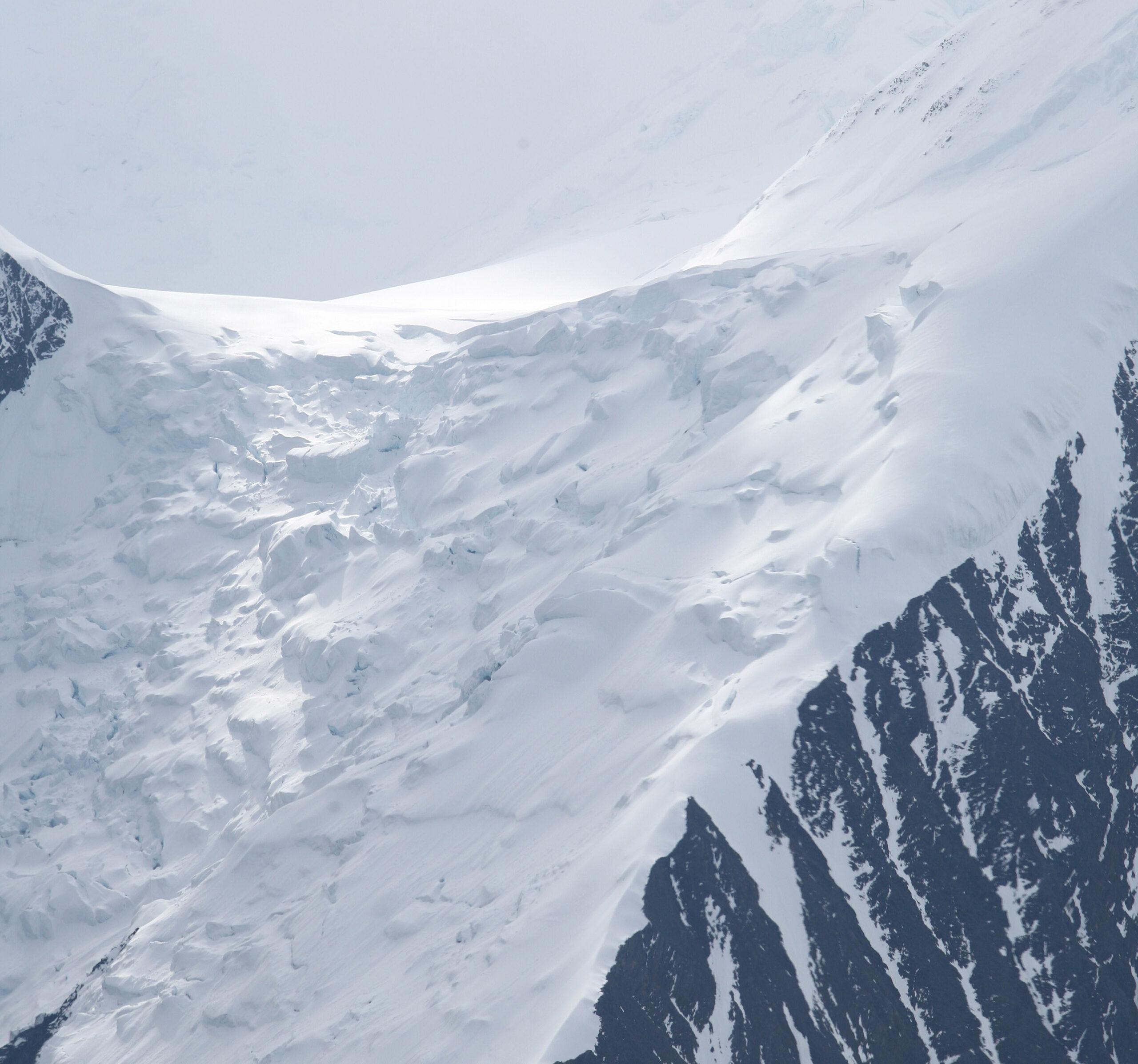 Using a polarizer, an aerial close-up view of sunlight on a glacier on the summit of Mount McKinley, Alaska, reveals beautiful striations on the right. Such a lens helps cut down on glare, especially with snow shots./Getty Images