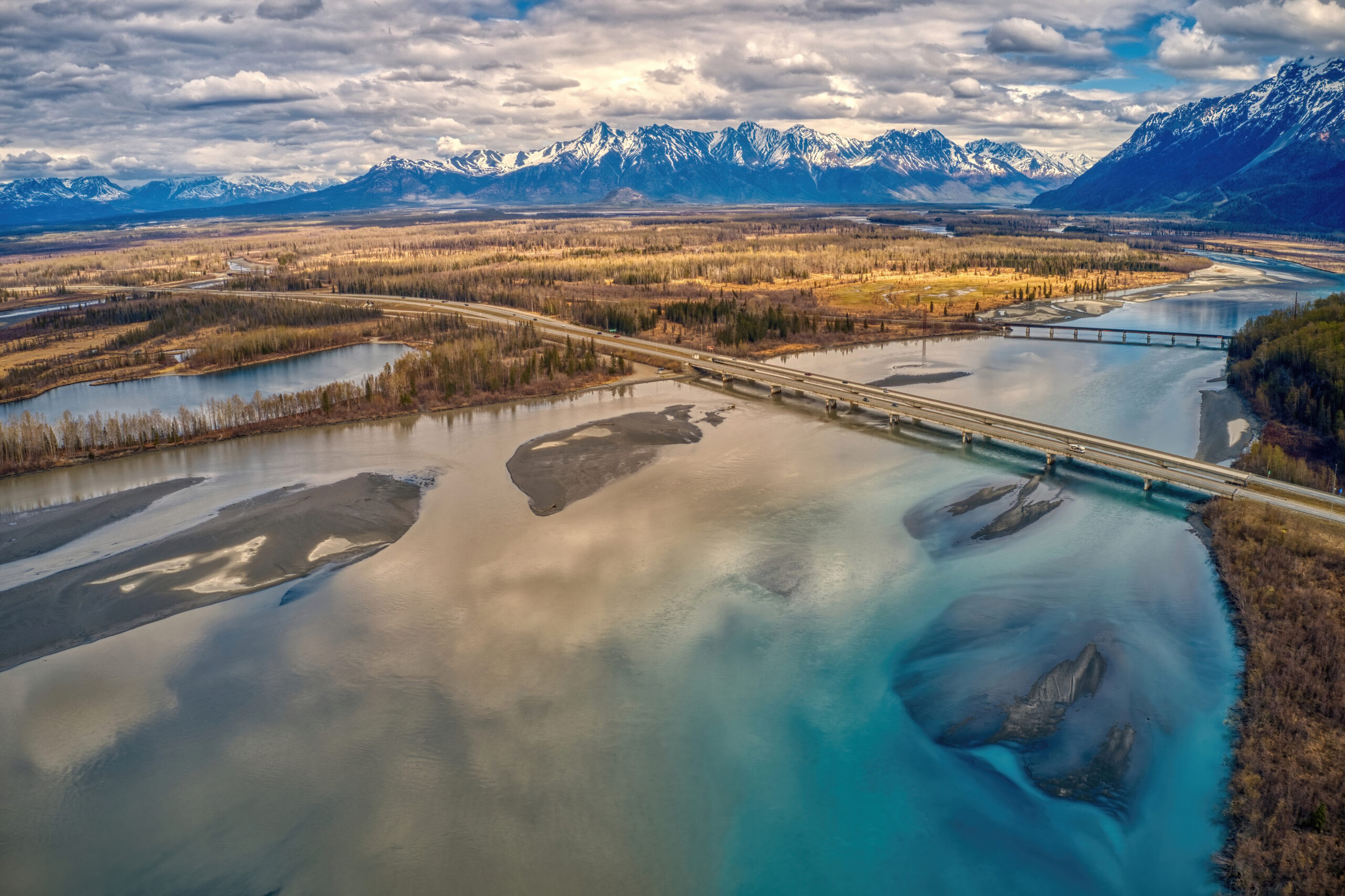 From a flightseeing plane, you can see the sweep of Alaska as this photo of the Glen Highway crossing the Knik River demonstrates./Shutterstock