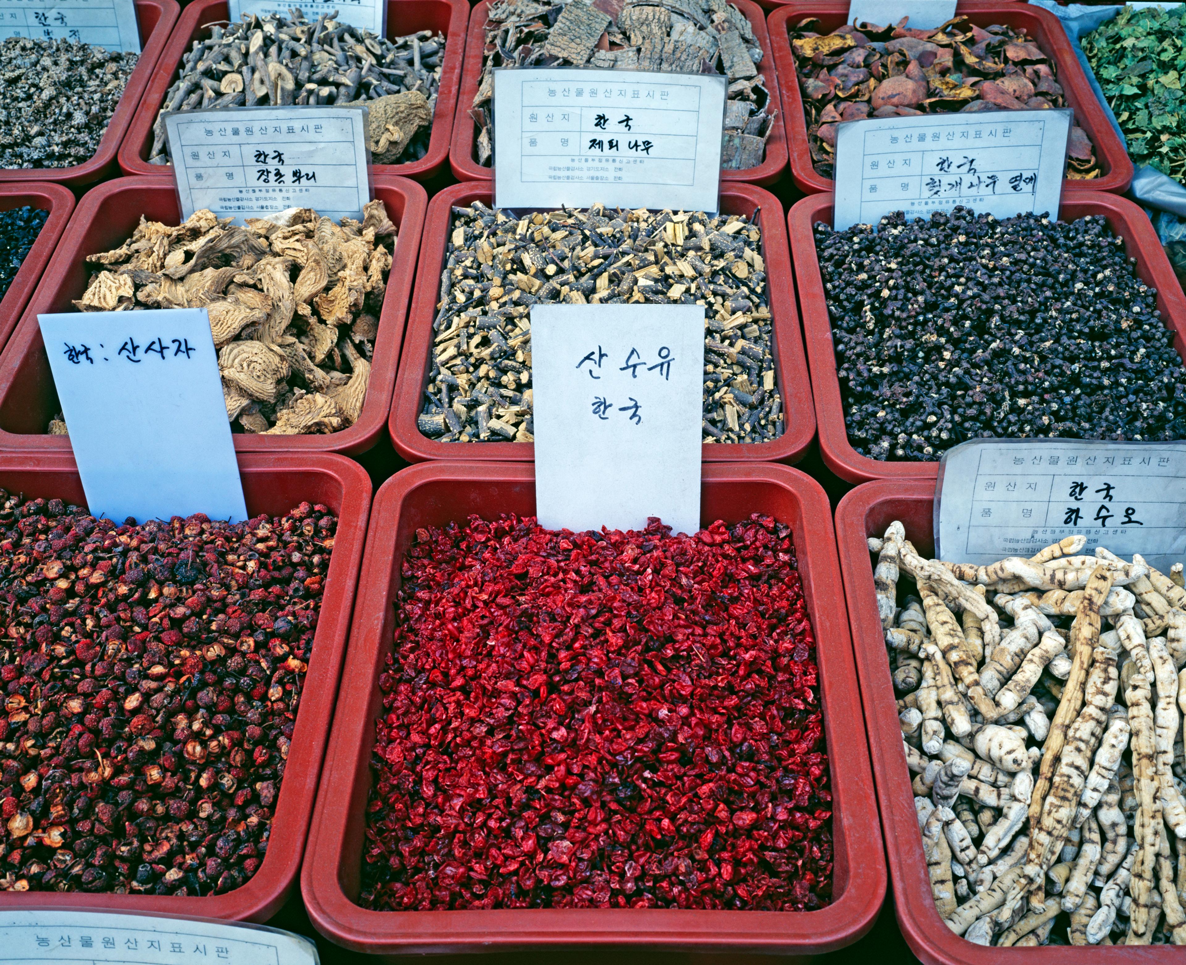 View of medicinal herbs, dried plants, berries and tree barks in tubs at Gyeongdong Market in Seoul/Getty Images