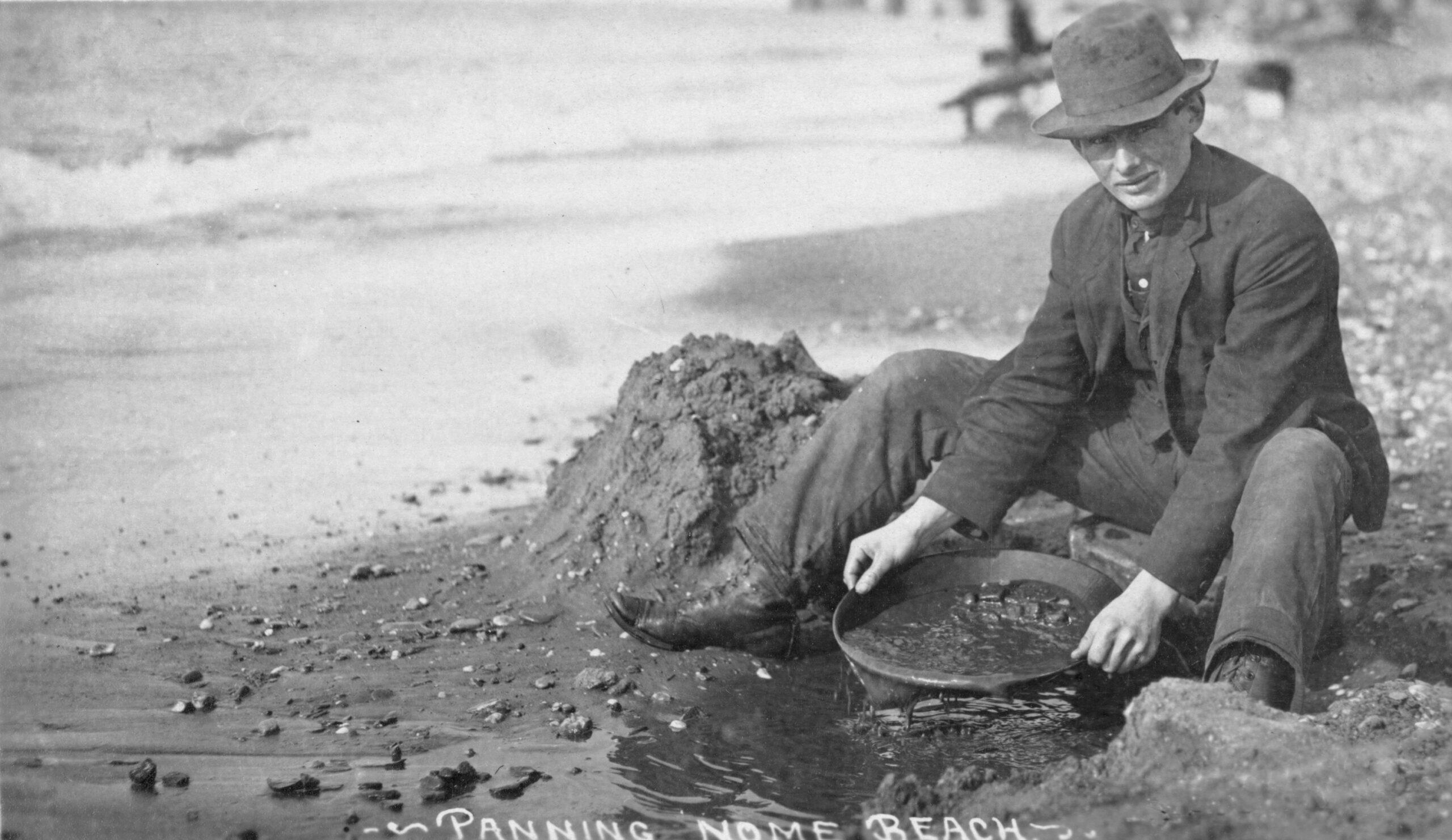 This photo from the early 1900s shows a gold seeker panning on Nome Beach in Alaska. There are places you can still try your luck. /Shutterstock