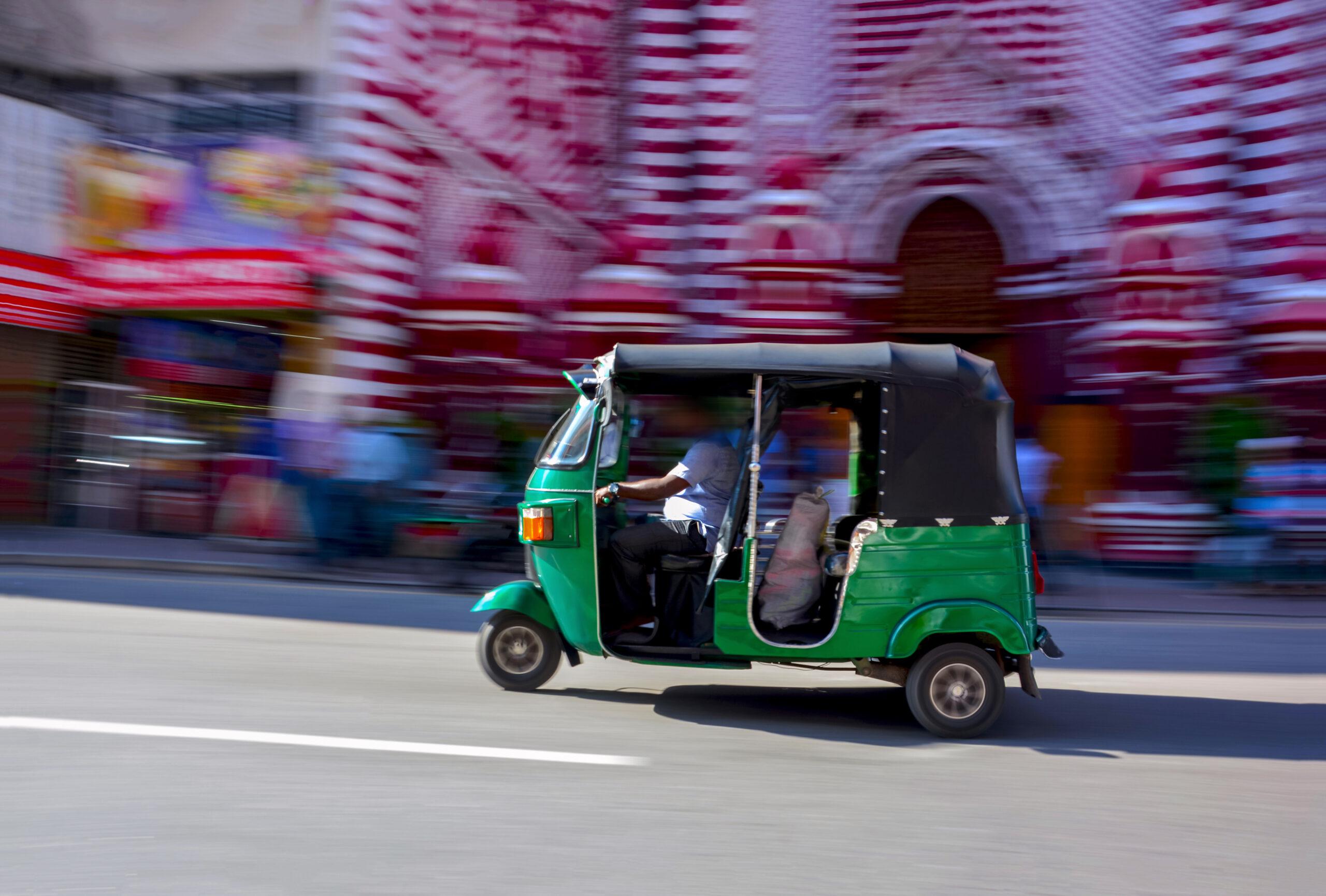 A tuk-tuk in front of the Red Mosque in Colombo, Sri Lanka./Shutterstock