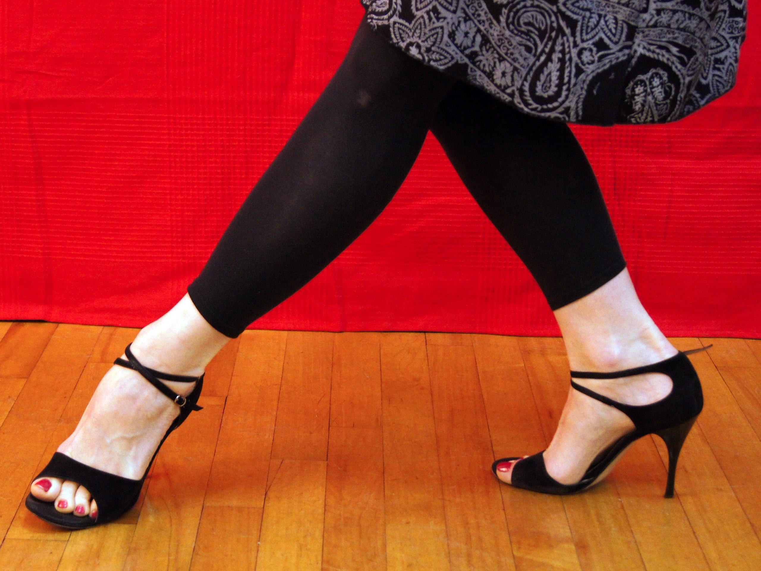 If you're planning on dancing the tango, women will need heels. Forward cross step extension. Wikimedia Commons photo by Pcirrus2