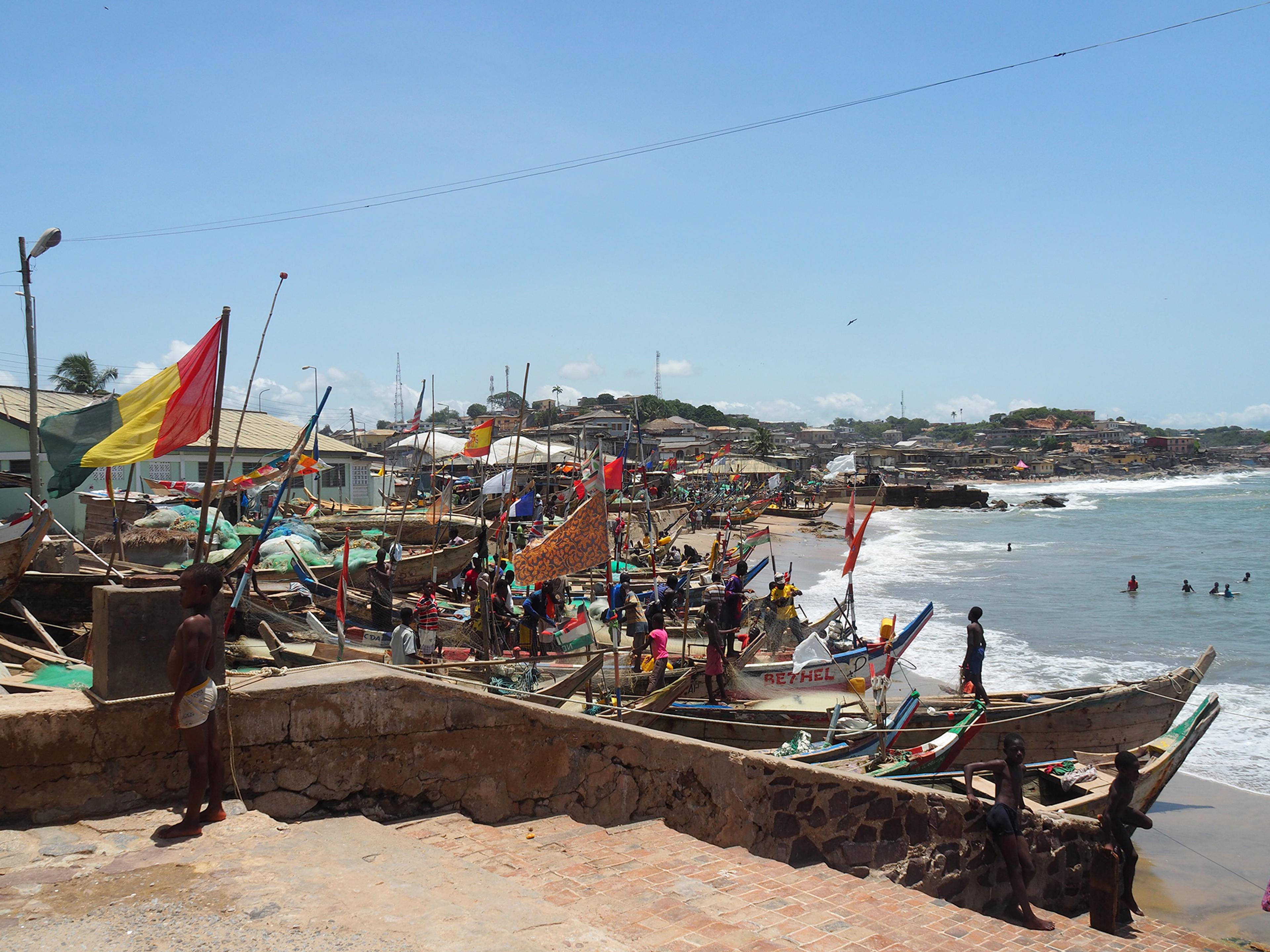 Fishing boats, called pirogues, line the beach next to Cape Coast Castle/ Alexandra Yingst