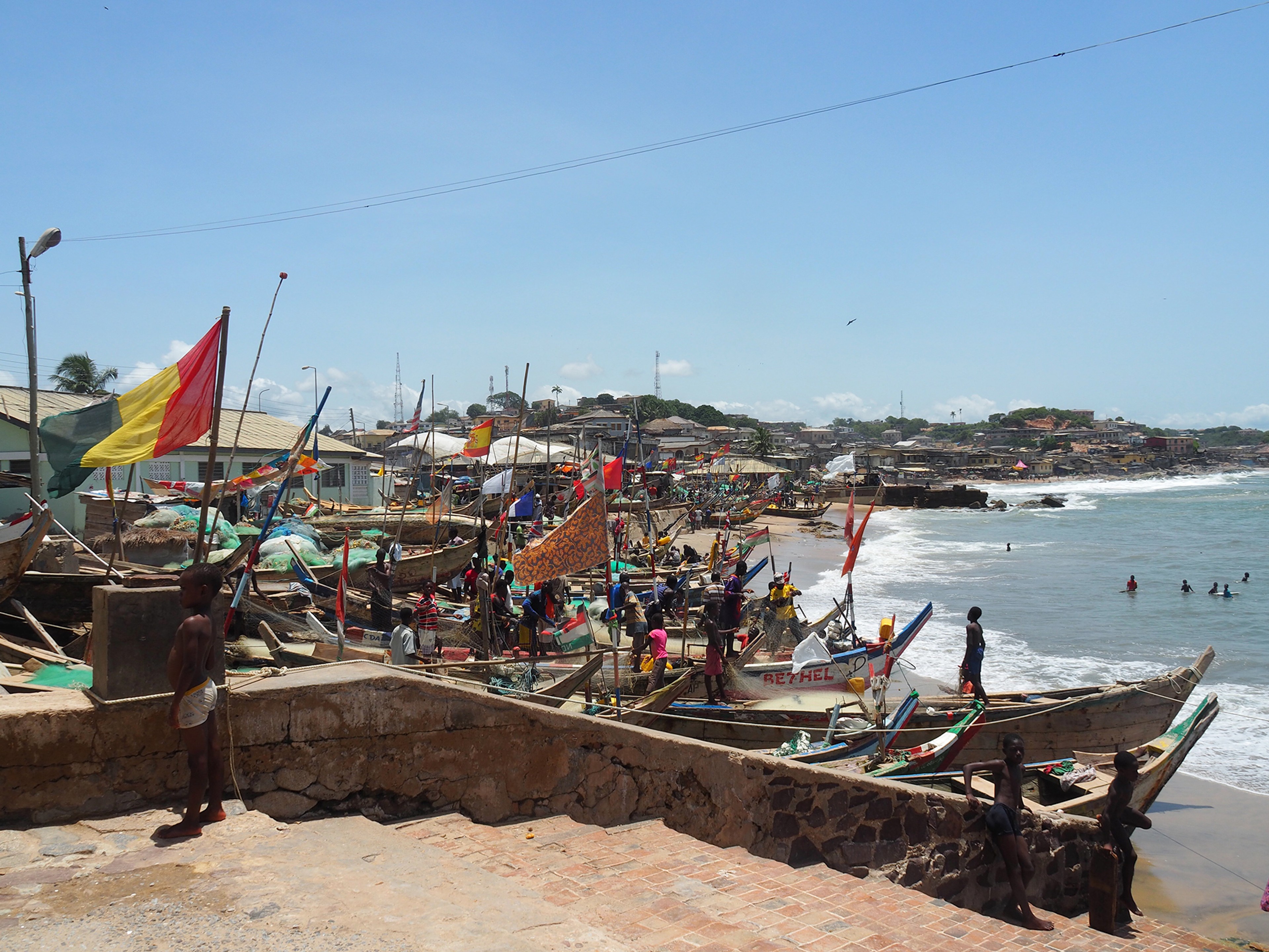 Fishing boats, called pirogues, line the beach next to Cape Coast Castle/ Alexandra Yingst
