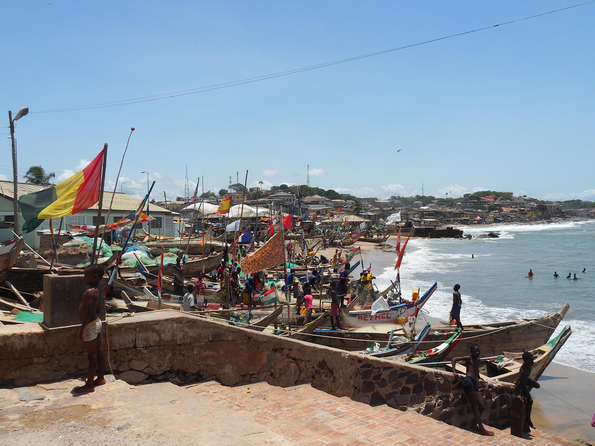 Fishing boats, called pirogues, line the beach next to Cape Coast Castle/ Alexandra Yingst