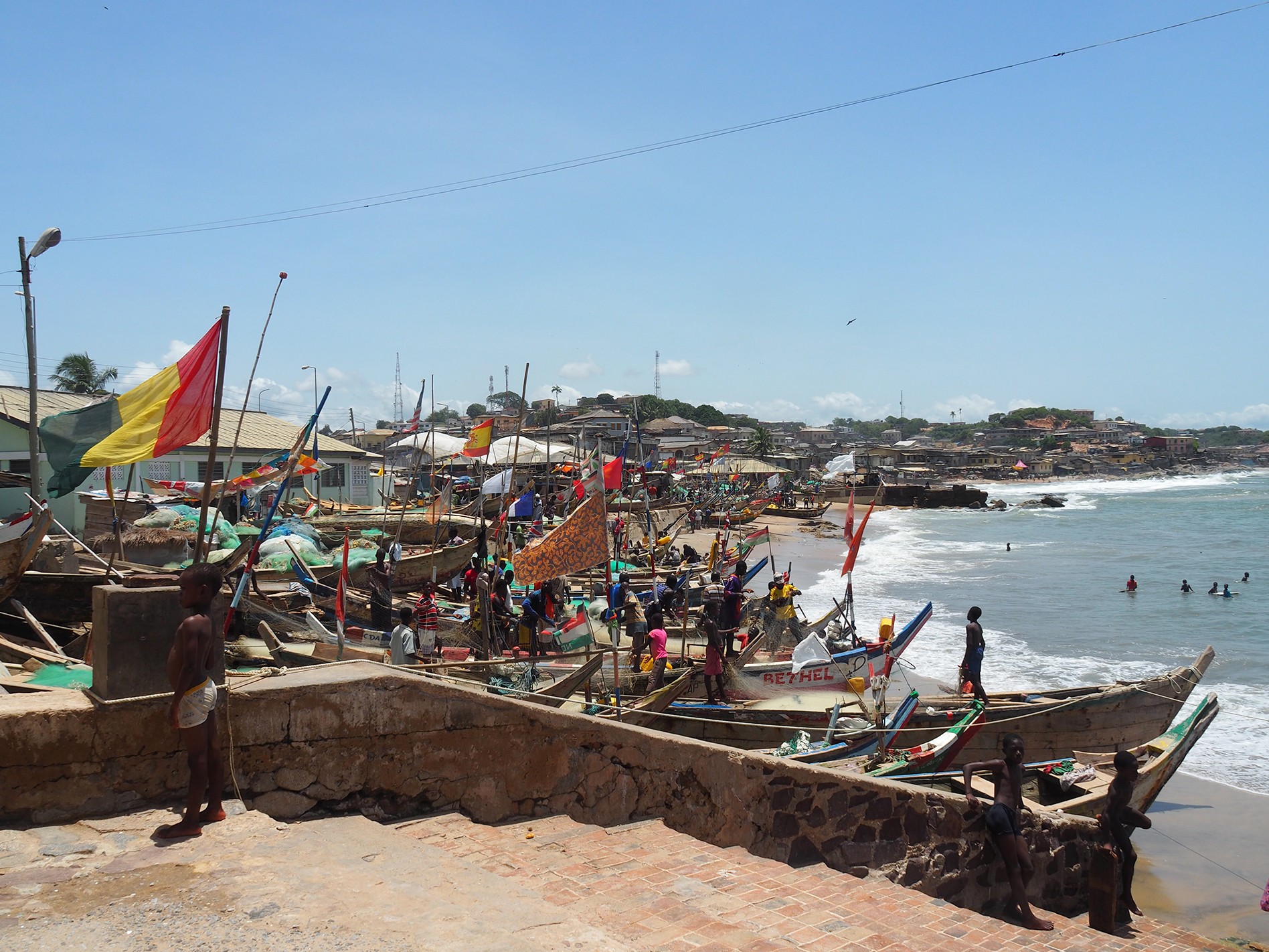 Fishing boats, called pirogues, line the beach next to Cape Coast Castle/ Alexandra Yingst