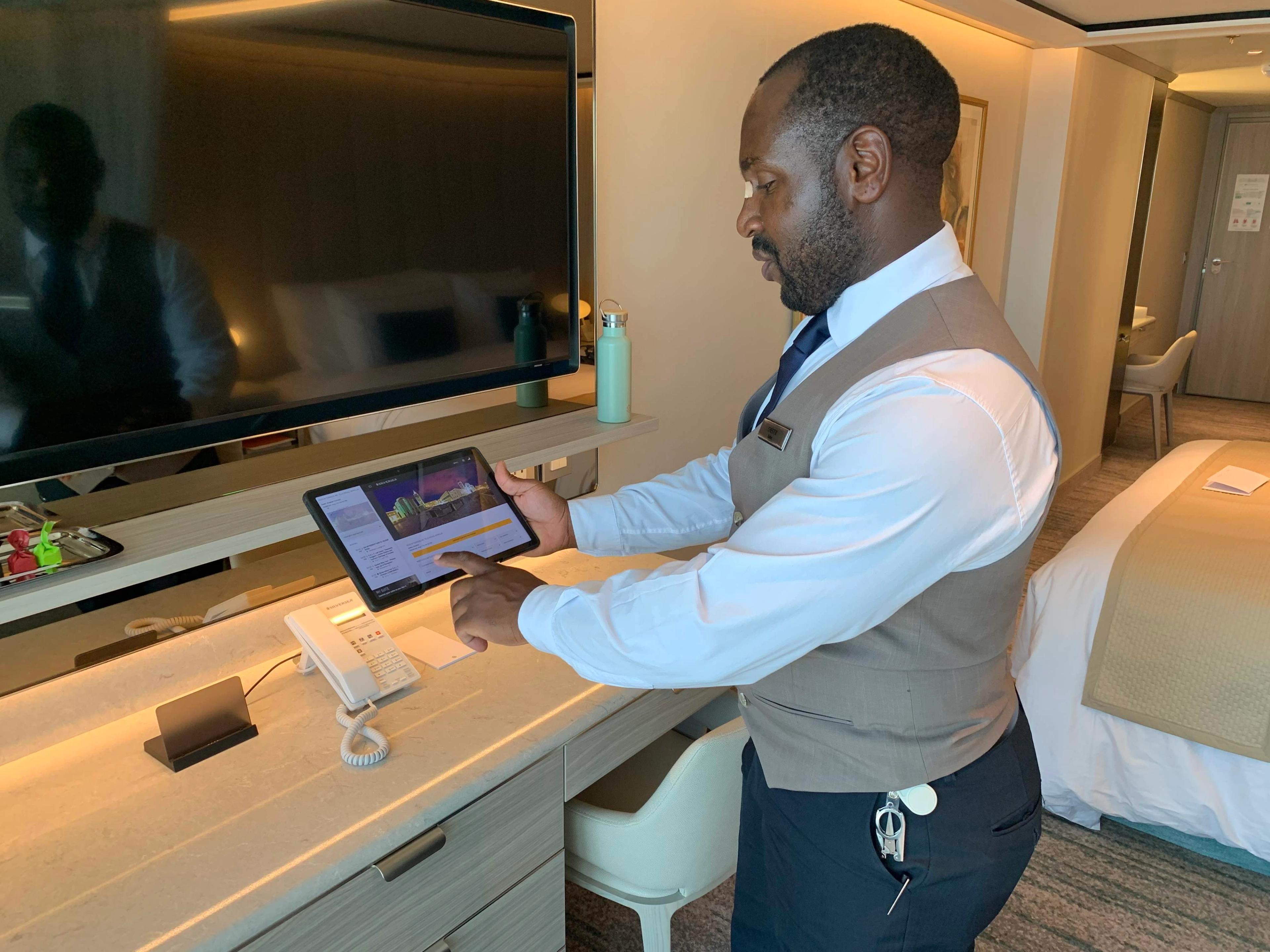 Chester, my butler, shows me how to work the Lenovo pad on Silver Nova. /Photo by Teijo Niemela for Silversea